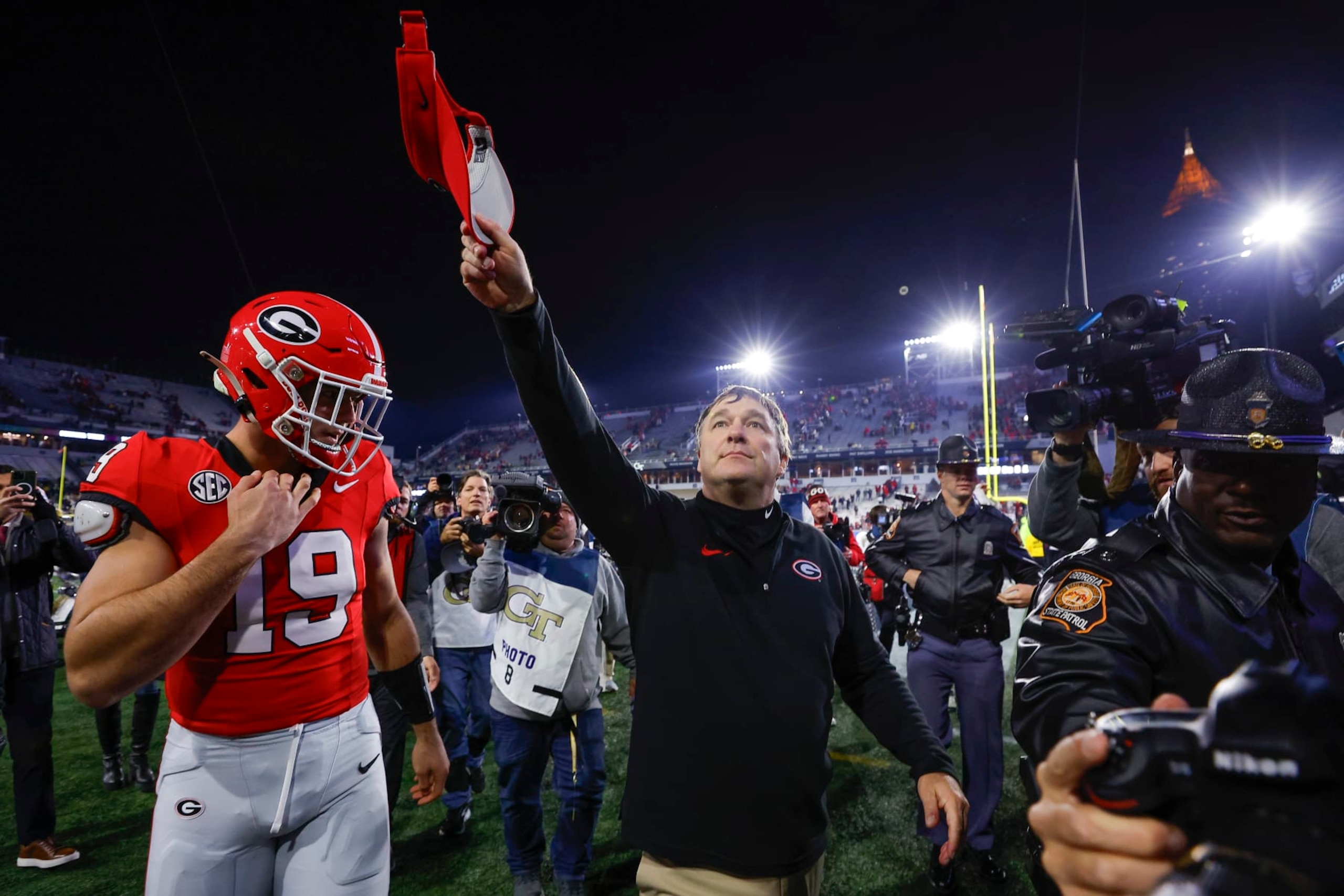 ATLANTA, GEORGIA - NOVEMBER 25: Head coach Kirby Smart leaves the field with Brock Bowers #19 of the Georgia Bulldogs following the 31-23 victory over the Georgia Tech Yellow Jackets at Bobby Dodd Stadium on November 25, 2023 in Atlanta, Georgia. (Photo by Todd Kirkland/Getty Images)