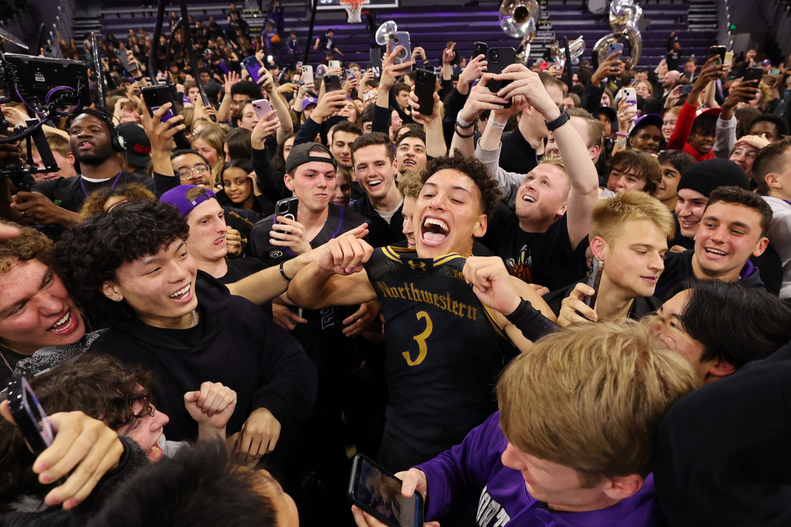 EVANSTON, ILLINOIS - DECEMBER 01: Ty Berry #3 of the Northwestern Wildcats celebrate with fans after defeating the Purdue Boilermakers 92-88 in overtime at Welsh-Ryan Arena on December 01, 2023 in Evanston, Illinois. (Photo by Michael Reaves/Getty Images)