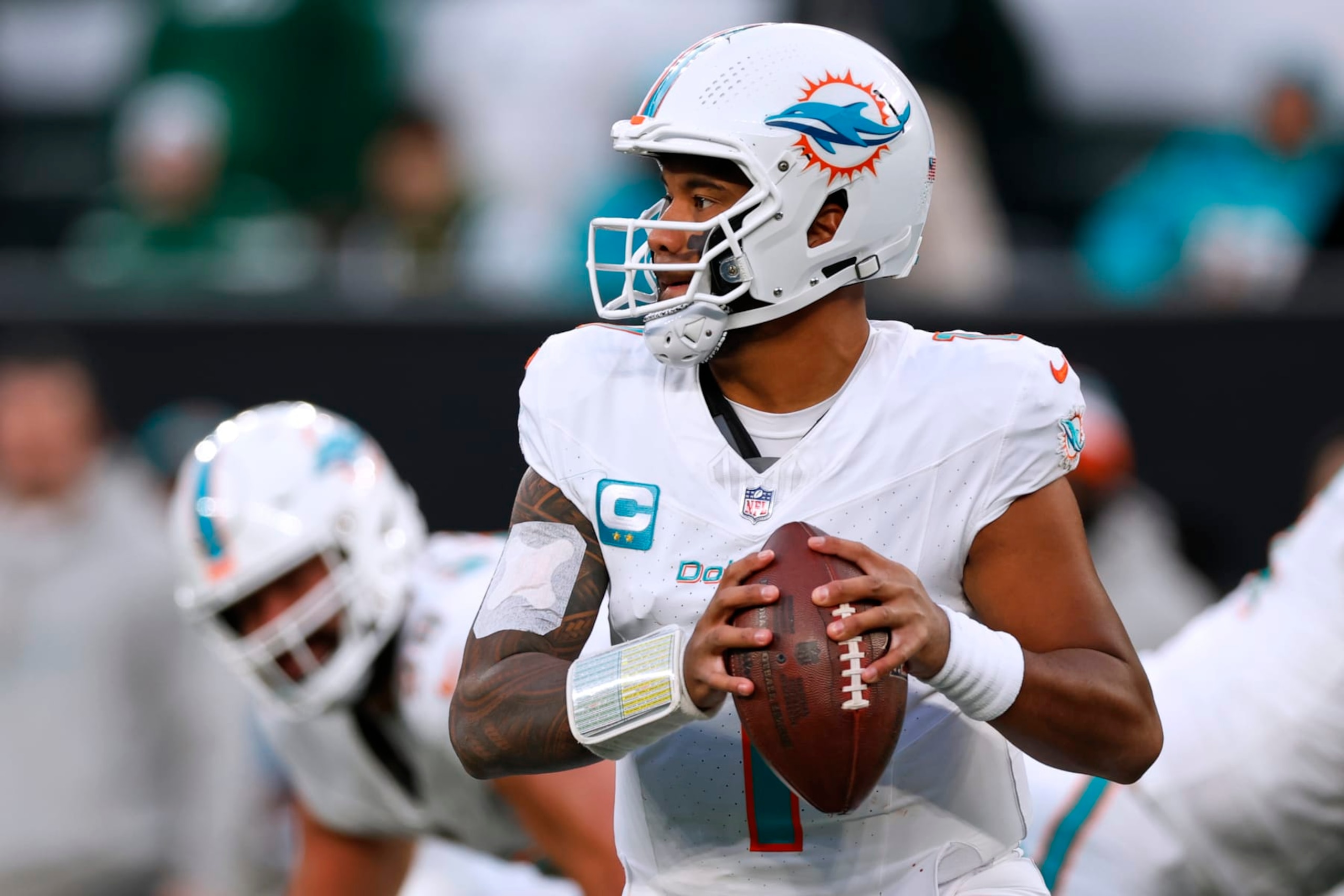 EAST RUTHERFORD, NEW JERSEY - NOVEMBER 24: Quarterback Tua Tagovailoa #1 of the Miami Dolphins in action against the New York Jets during a football game at MetLife Stadium on November 24, 2023 in East Rutherford, New Jersey. (Photo by Rich Schultz/Getty Images) EAST RUTHERFORD, NEW JERSEY - NOVEMBER 24: Quarterback Tua Tagovailoa #1 of the Miami Dolphins in action against the New York Jets during a football game at MetLife Stadium on November 24, 2023 in East Rutherford, New Jersey. (Photo by Rich Schultz/Getty Images)