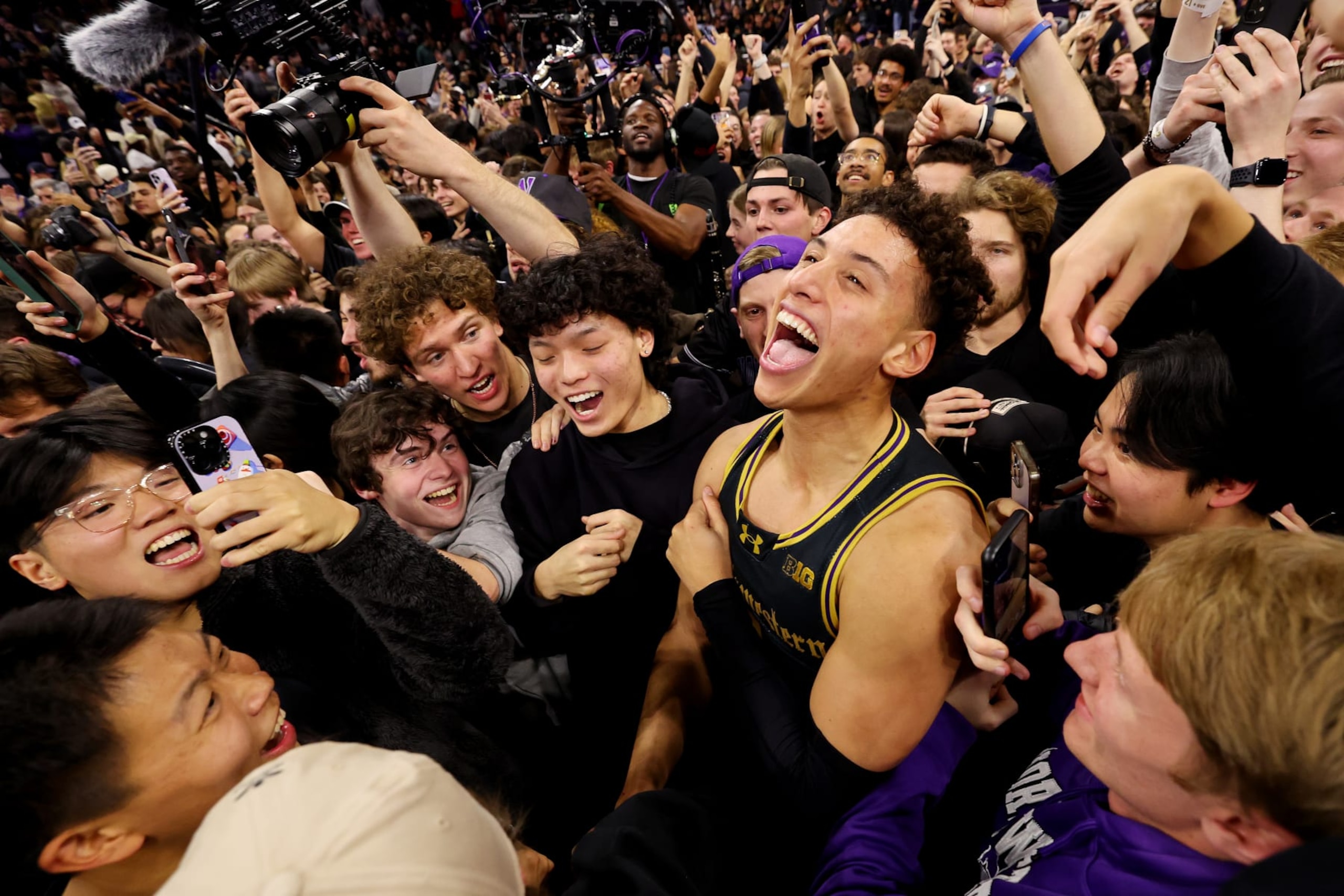 EVANSTON, ILLINOIS - DECEMBER 01: Ty Berry #3 of the Northwestern Wildcats celebrate with fans after defeating the Purdue Boilermakers 92-88 in overtime at Welsh-Ryan Arena on December 01, 2023 in Evanston, Illinois. (Photo by Michael Reaves/Getty Images)