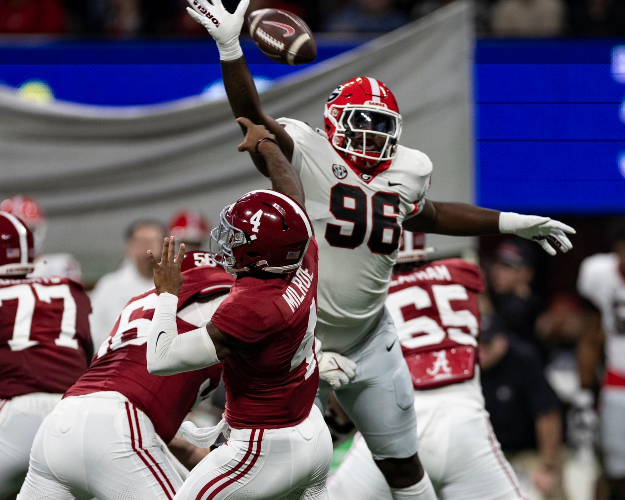 ATLANTA, GA - DECEMBER 2: Zion Logue #96 of the Georgia Bulldogs tips a pass by Jalen Milroe #4 of the Alabama Crimson Tide during a game between University of Georgia and University of Alabama at Mercedes-Benz Stadium on December 2, 2023 in Atlanta, Georgia. (Photo by Steve Limentani/ISI Photos/Getty Images)