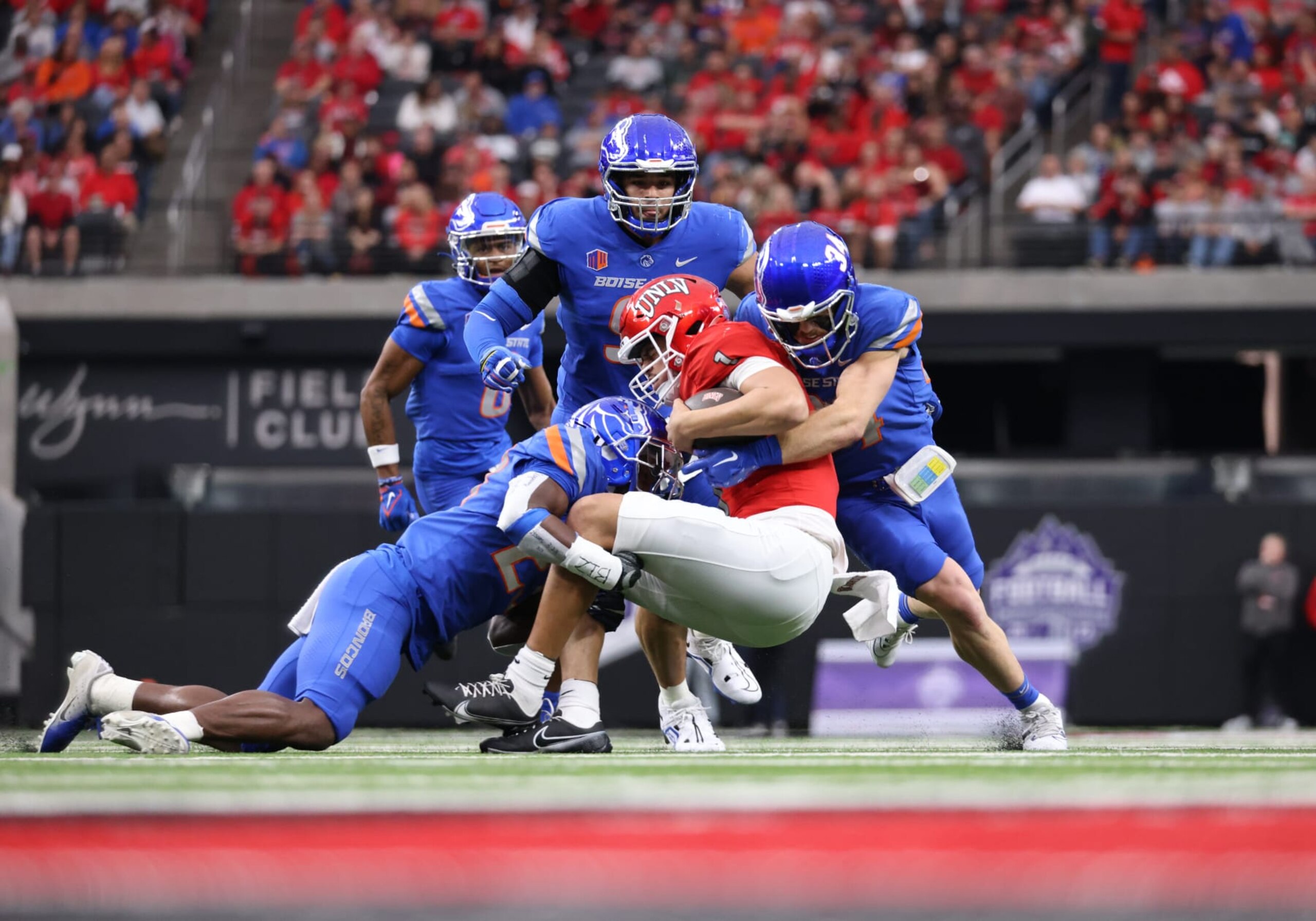 LAS VEGAS, NV - DECEMBER 02: Boise State Broncos safety Seyi Oladipo (23) and safety Alexander Teubner (34) tackle UNLV Rebels quarterback Jayden Maiava (1) during a Mountain West Championship Game between the Boise State Broncos and the UNLV Rebels Saturday, Dec. 2, 2023, at Allegiant Stadium in Las Vegas, Nevada. (Photo by Marc Sanchez/Icon Sportswire via Getty Images)
