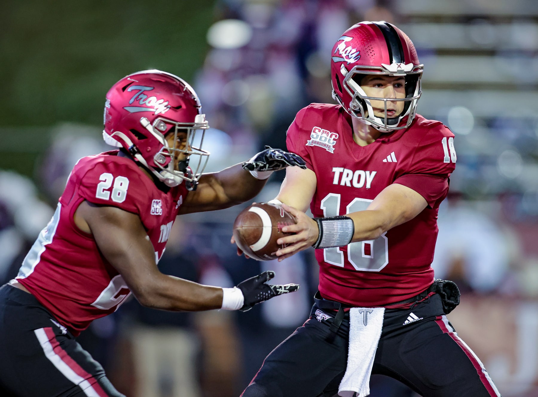 TROY, ALABAMA - NOVEMBER 2: Gunnar Watson #18 hands the ball off to Kimani Vidal #28 of the Troy Trojans during the first half at Veterans Memorial Stadium on November 2, 2023 in Troy, Alabama. (Photo by Brandon Sumrall/Getty Images)