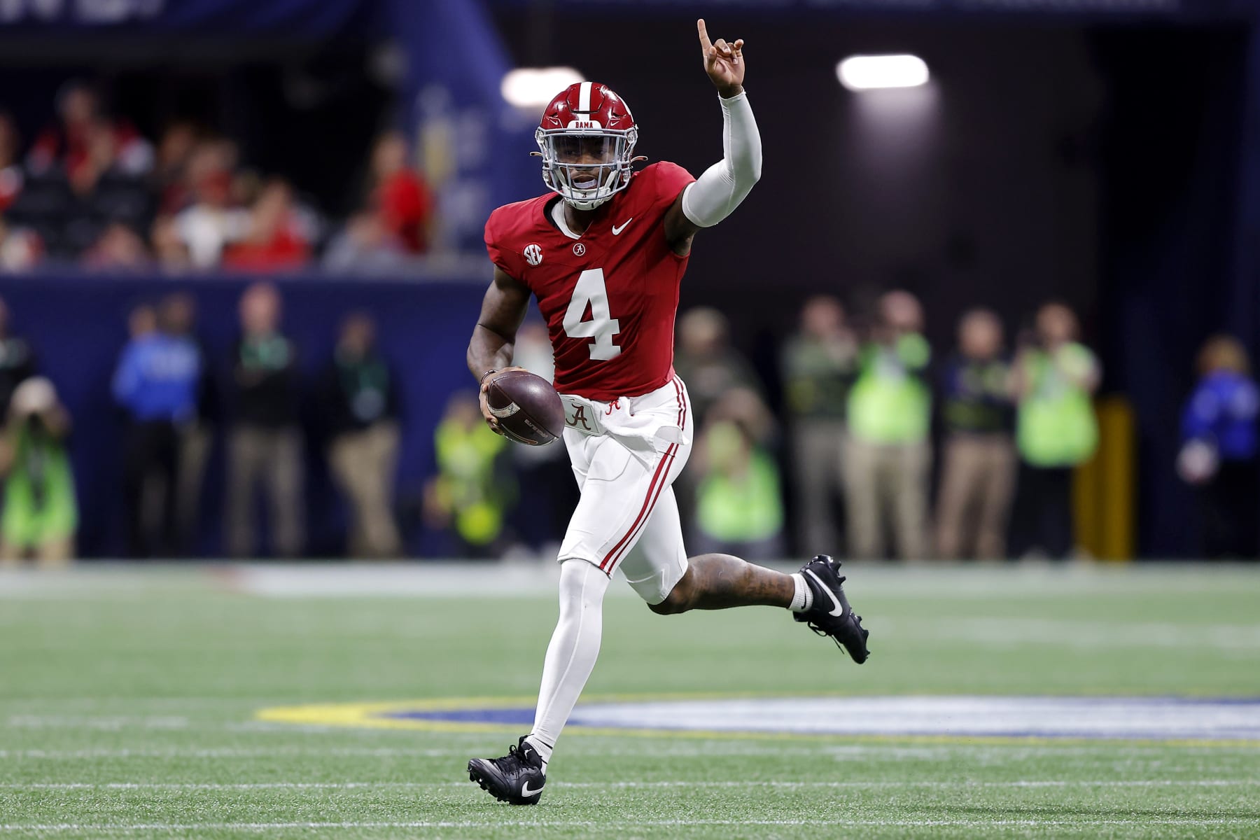 ATLANTA, GEORGIA - DECEMBER 02: Jalen Milroe #4 of the Alabama Crimson Tide runs out of the pocket during the first quarter against the Georgia Bulldogs  in the SEC Championship at Mercedes-Benz Stadium on December 02, 2023 in Atlanta, Georgia. (Photo by Todd Kirkland/Getty Images)
