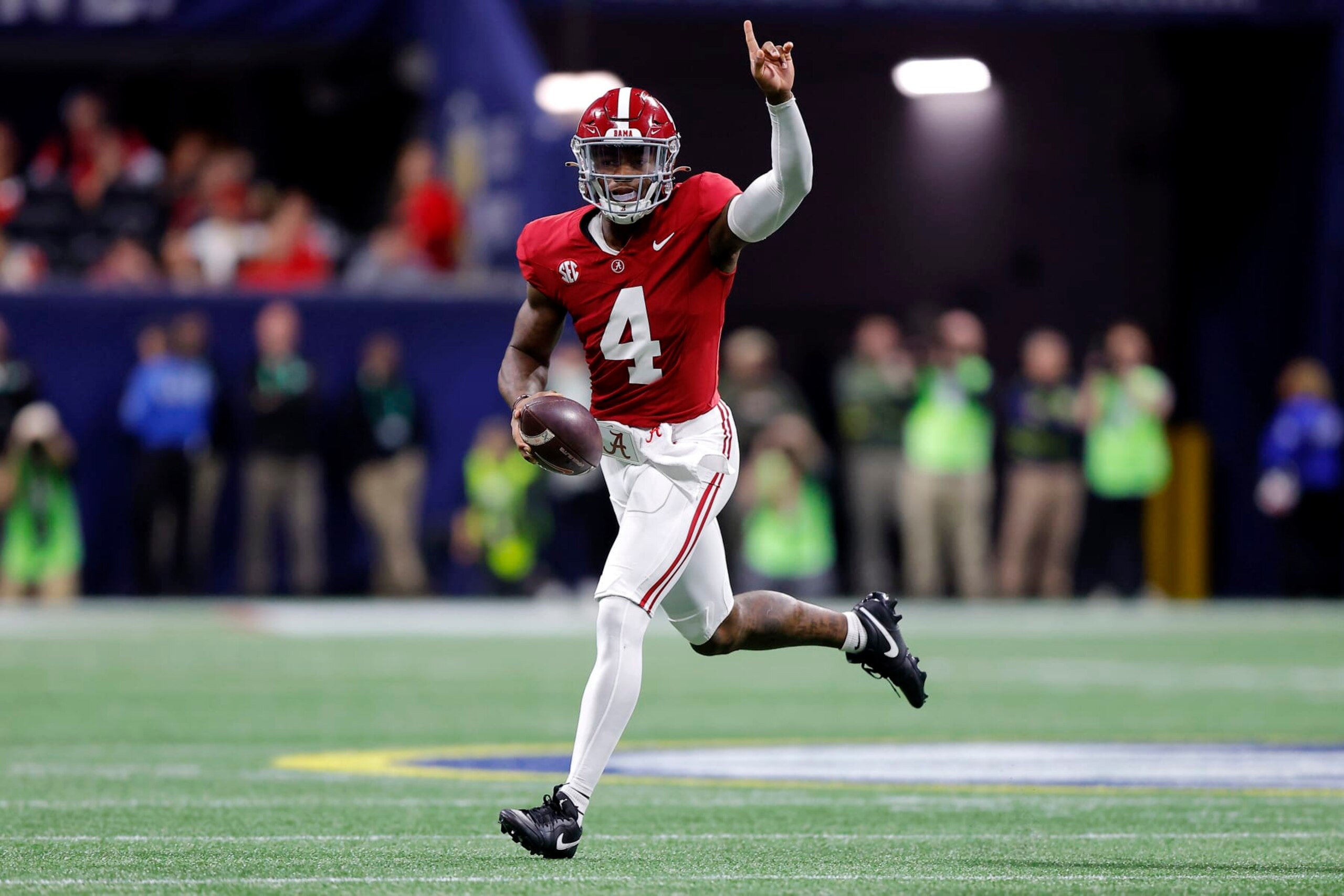 ATLANTA, GEORGIA - DECEMBER 02: Jalen Milroe #4 of the Alabama Crimson Tide runs out of the pocket during the first quarter against the Georgia Bulldogs  in the SEC Championship at Mercedes-Benz Stadium on December 02, 2023 in Atlanta, Georgia. (Photo by Todd Kirkland/Getty Images)
