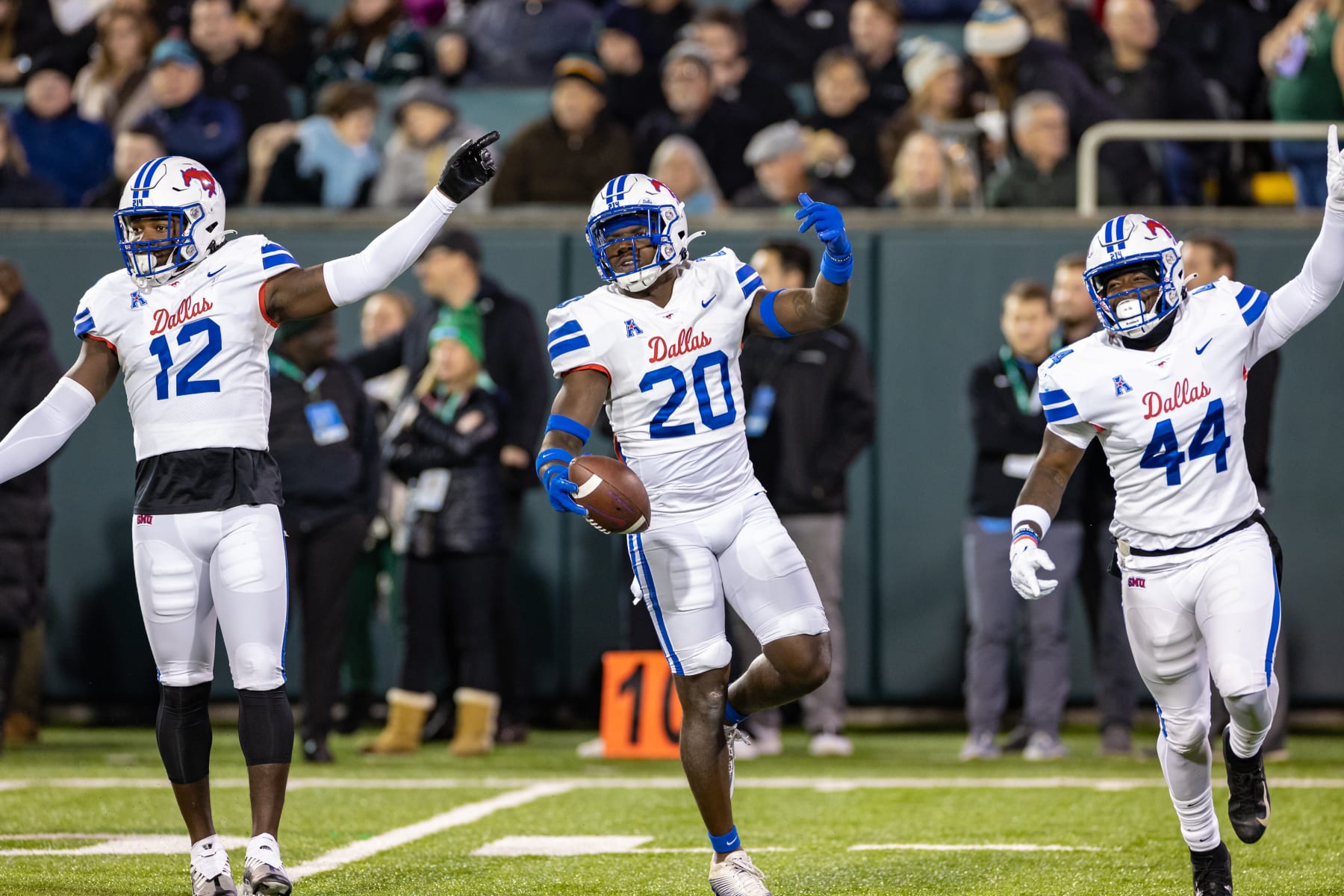 DALLAS, TX - NOVEMBER 17: SMU Mustangs safety Chris Adimora (#20) and tlinebackers Shanon Reid (#12) and Kamryn Farrar (#44) celebrate after a turnover during the college football game between the SMU Mustangs and the Tulane Green Wave on November 17, 2022, at Benson Fiend at Yulman Stadium in New Orleans, LA.  (Photo by Matthew Visinsky/Icon Sportswire via Getty Images)