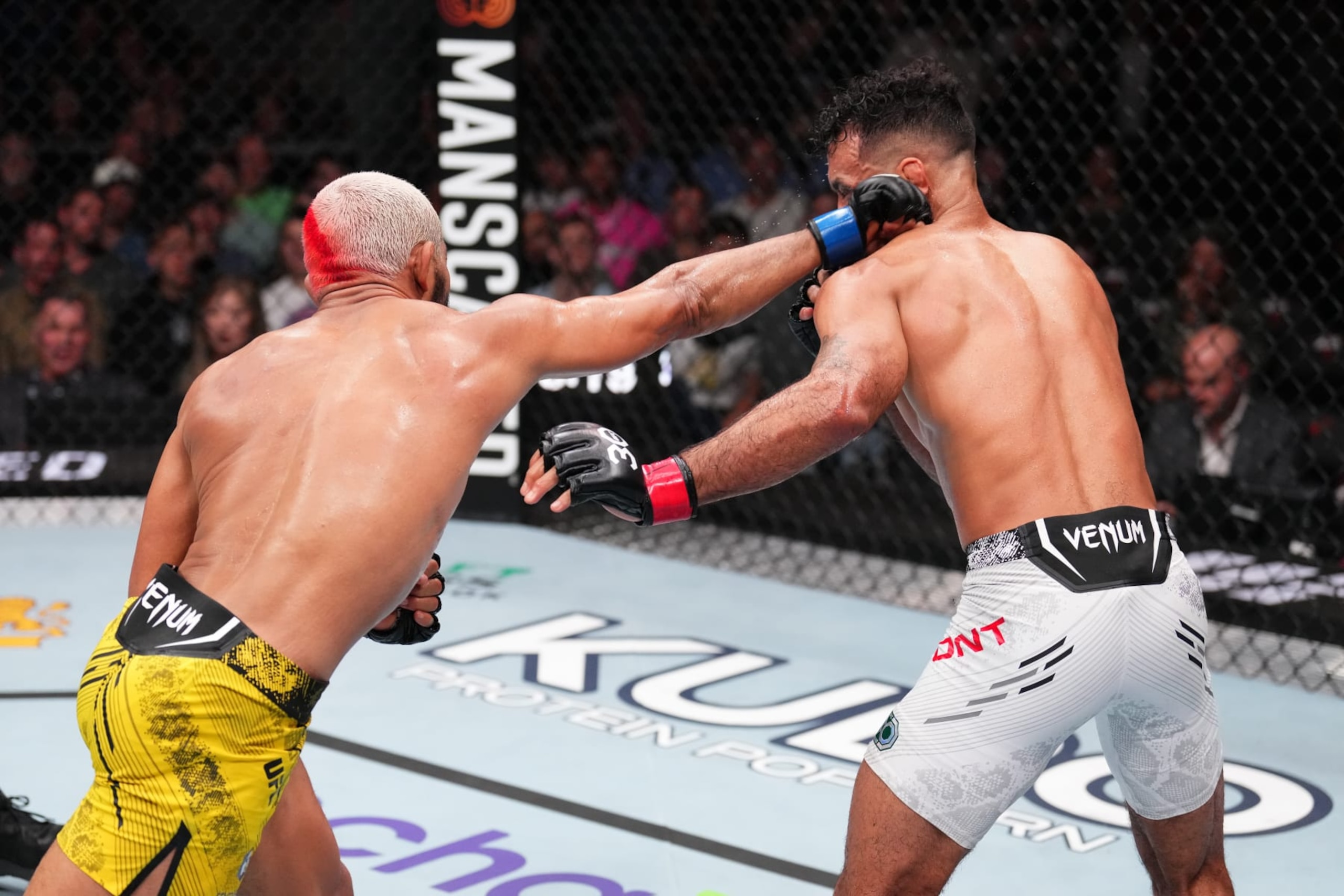 AUSTIN, TEXAS - DECEMBER 02: (L-R) Deiveson Figueiredo of Brazil punches Rob Font in a bantamweight fight during the UFC Fight Night event at Moody Center on December 02, 2023 in Austin, Texas. (Photo by Josh Hedges/Zuffa LLC via Getty Images)