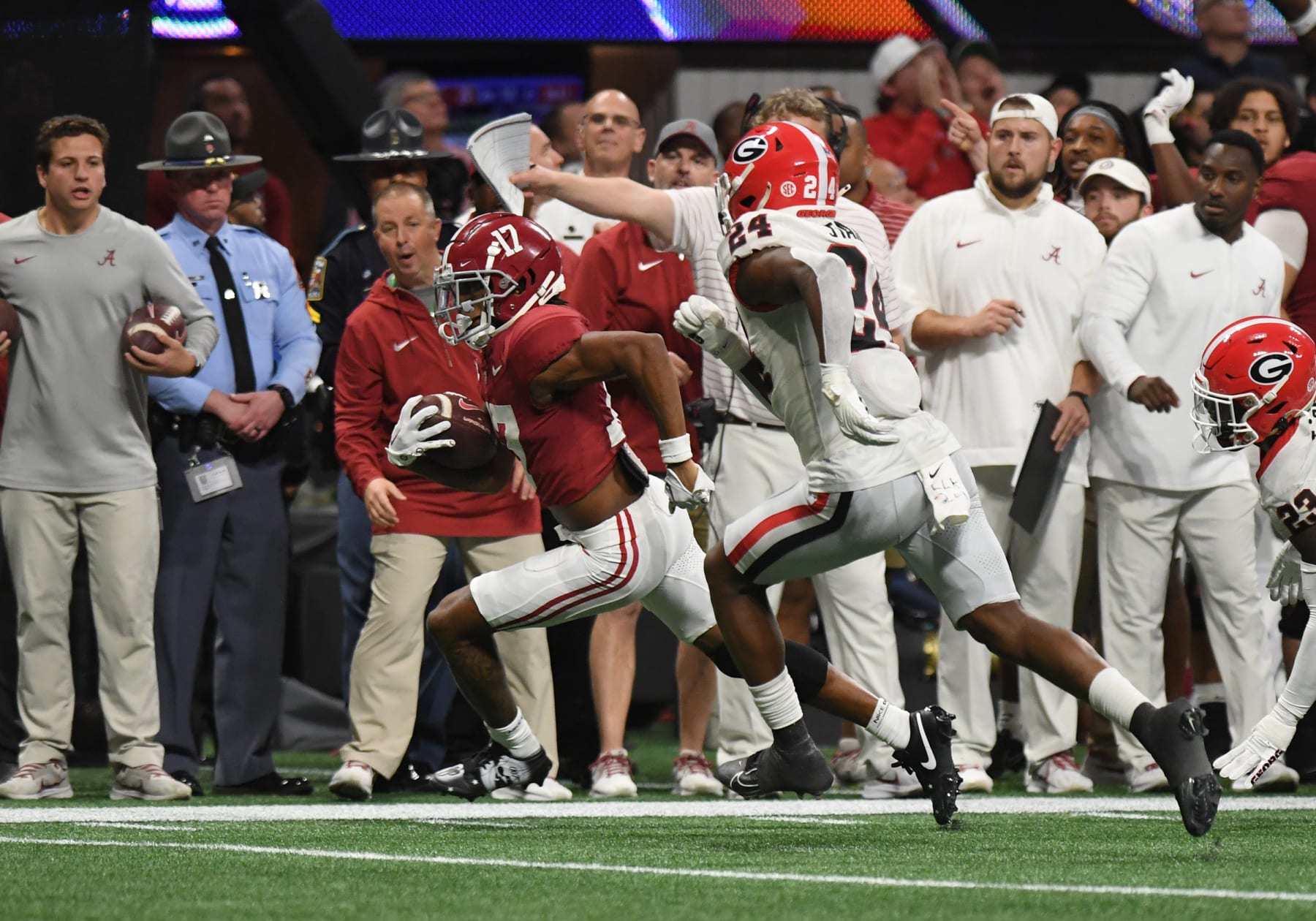 ATLANTA, GA - DECEMBER 02: Alabama Crimson Tide Wide Receiver Isaiah Bond (17) rushes the ball as Georgia Bulldogs Defensive Back Malaki Starks (24) defends during the SEC Championship Game between the Georgia Bulldogs and the Alabama Crimson Tide on December 02, 2023, at Mercedes-Benz Stadium in Atlanta, GA. (Photo by Jeffrey Vest/Icon Sportswire via Getty Images)