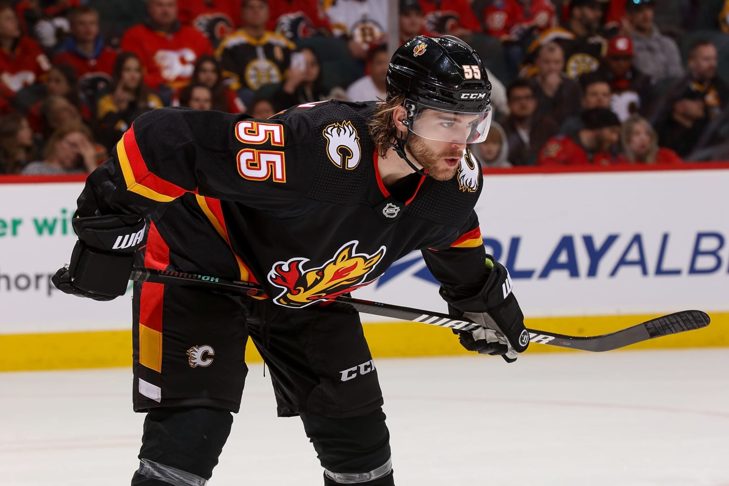CALGARY, AB - FEBRUARY 28: Noah Hanifin #55 of the Calgary Flames prepares to face off against the Boston Bruins at Scotiabank Saddledome on February 28, 2023 in Calgary, Alberta, Canada. (Photo by Gerry Thomas/NHLI via Getty Images)