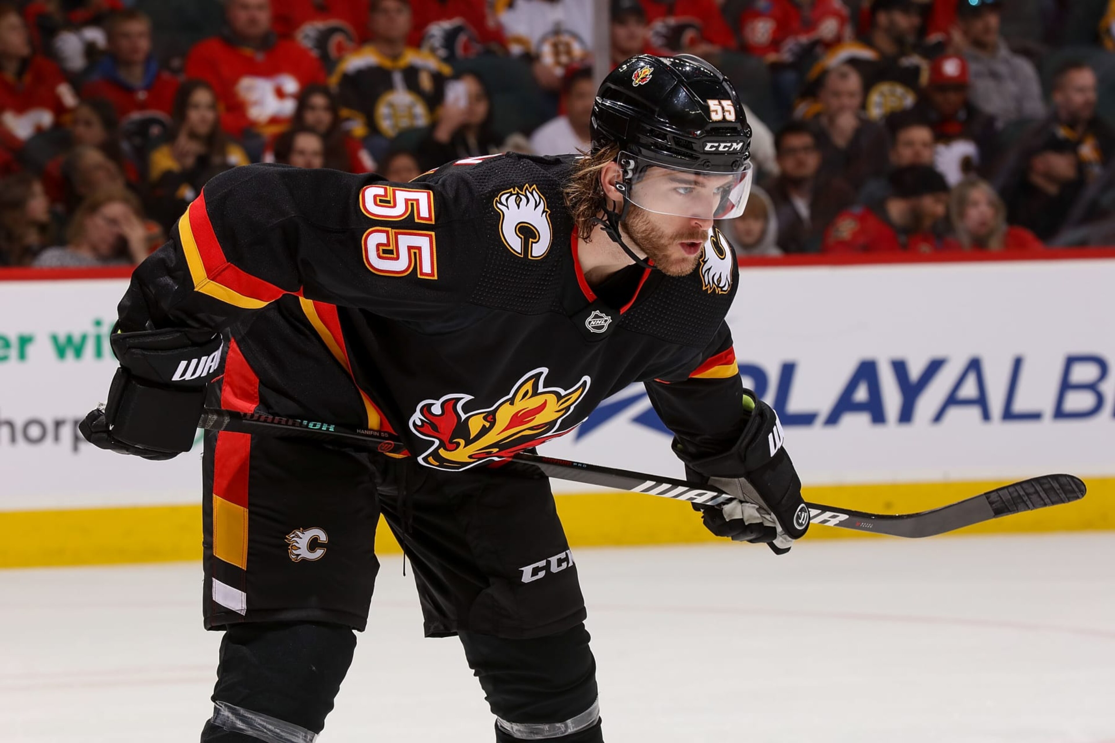 CALGARY, AB - FEBRUARY 28: Noah Hanifin #55 of the Calgary Flames prepares to face off against the Boston Bruins at Scotiabank Saddledome on February 28, 2023 in Calgary, Alberta, Canada. (Photo by Gerry Thomas/NHLI via Getty Images)