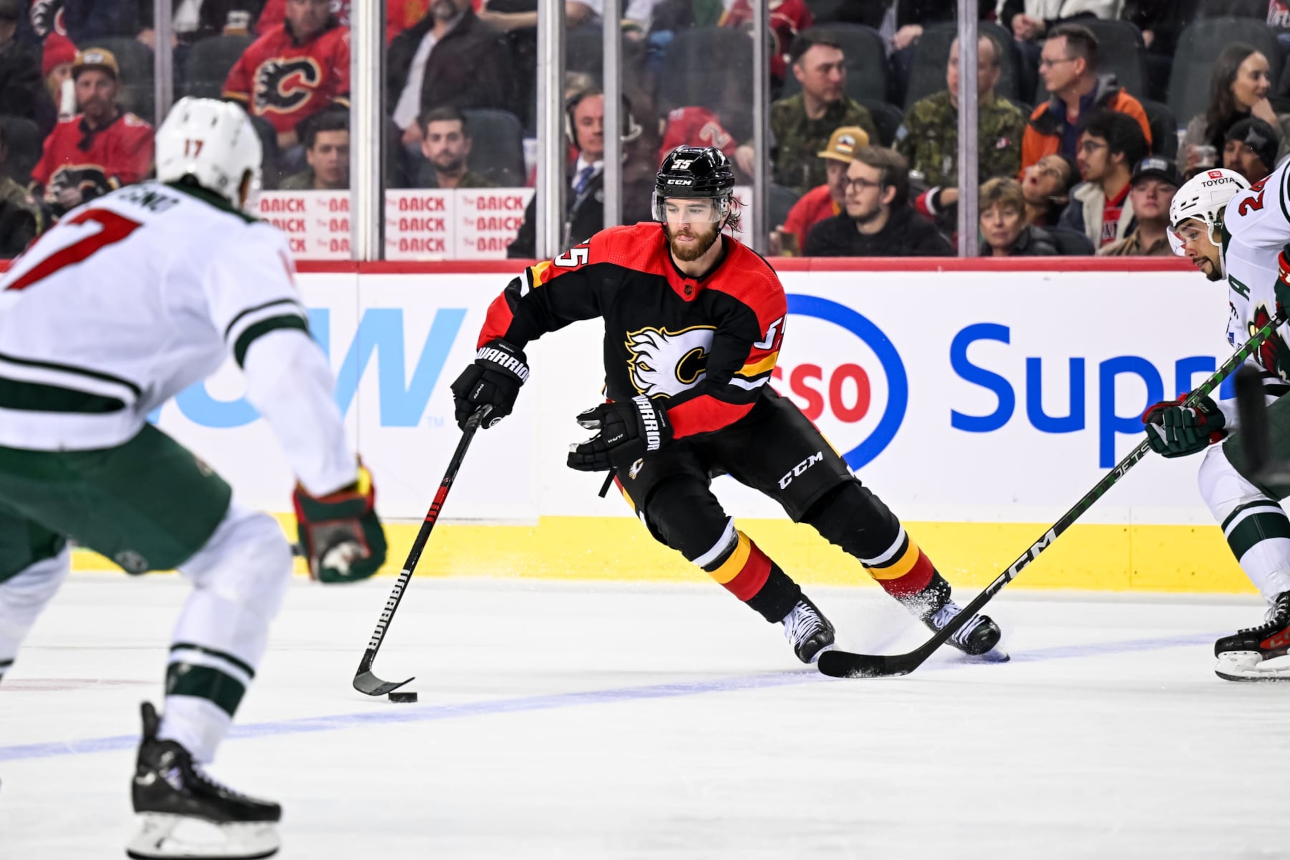 CALGARY, AB - DECEMBER 07: Calgary Flames Defenceman Noah Hanifin (55) skates up the ice with the puck during the third period of an NHL game between the Calgary Flames and the Minnesota Wild on December 7, 2022, at the Scotiabank Saddledome in Calgary, AB. (Photo by Brett Holmes/Icon Sportswire via Getty Images)