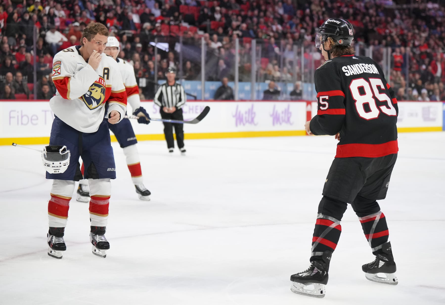 OTTAWA, CANADA - NOVEMBER 27:  Matthew Tkachuk #19 of the Florida Panthers takes off his helmet as he prepares to fight against Jake Sanderson #85 of the Ottawa Senators during the third period at Canadian Tire Centre on November 27, 2023 in Ottawa, Ontario, Canada.  (Photo by André Ringuette/NHLI via Getty Images)