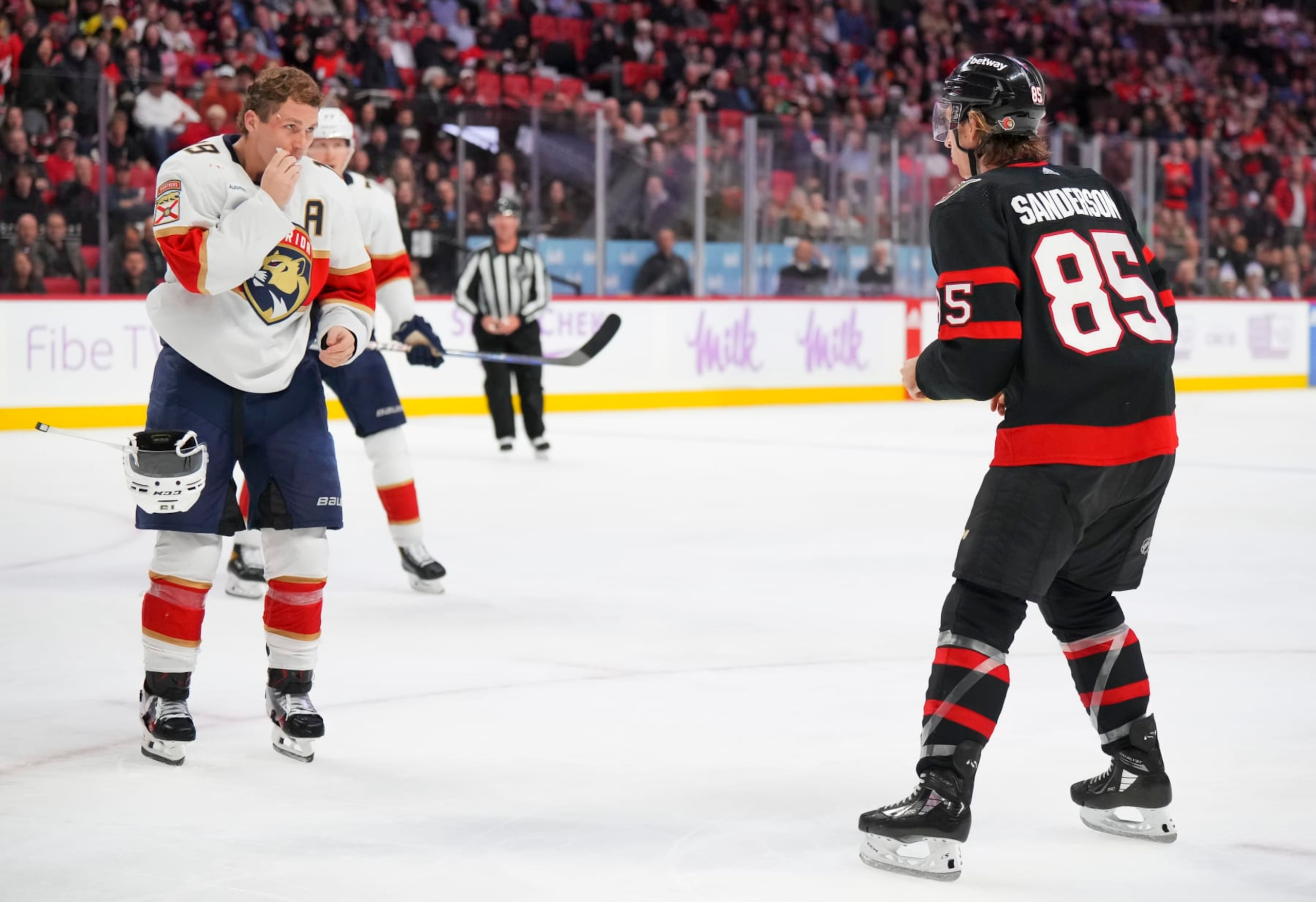OTTAWA, CANADA - NOVEMBER 27:  Matthew Tkachuk #19 of the Florida Panthers takes off his helmet as he prepares to fight against Jake Sanderson #85 of the Ottawa Senators during the third period at Canadian Tire Centre on November 27, 2023 in Ottawa, Ontario, Canada.  (Photo by André Ringuette/NHLI via Getty Images)