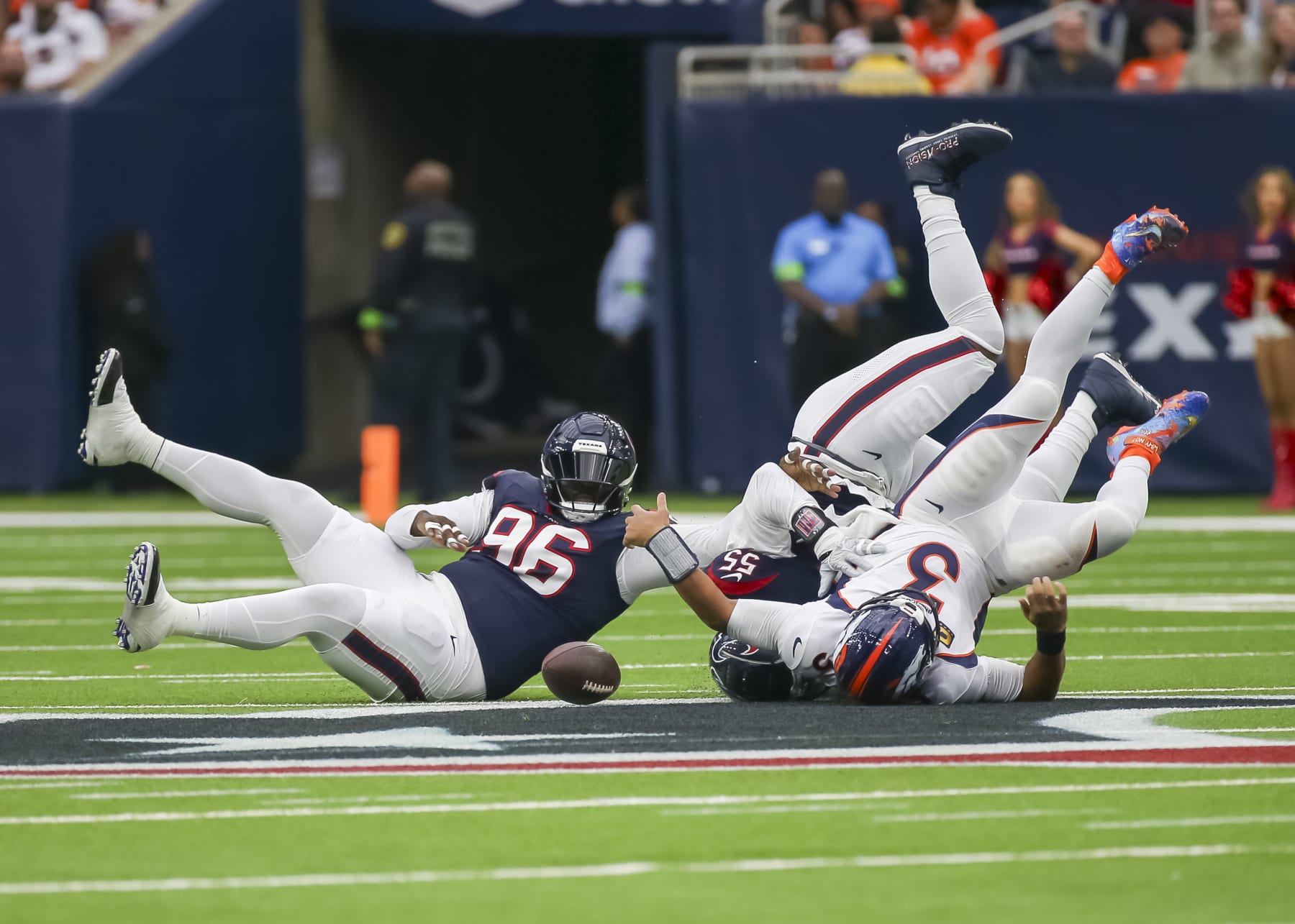 HOUSTON, TX - DECEMBER 03: Houston Texans defensive end Jerry Hughes (55) tackles Denver Broncos quarterback Russell Wilson (3) in the first quarter during the football game between Denver Broncos and Houston Texans at NRG Stadium on December 3, 2023 in Houston, Texas.  (Photo by Leslie Plaza Johnson/Icon Sportswire via Getty Images)