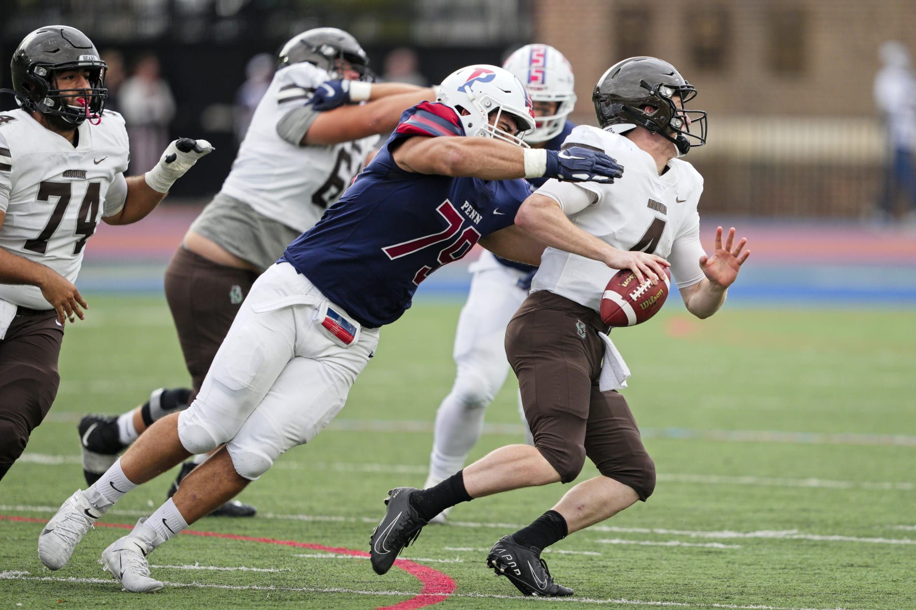 PHILADELPHIA, PA - OCTOBER 30: Pennsylvania Quakers defensive lineman Joey Slackman (79) sacks Brown Bears quarterback EJ Perry (4) during the game between the Pennsylvania Quakers and the Brown Bears on October 30, 2021 at Franklin Field in Philadelphia, PA. (Photo by Andy Lewis/Icon Sportswire via Getty Images)