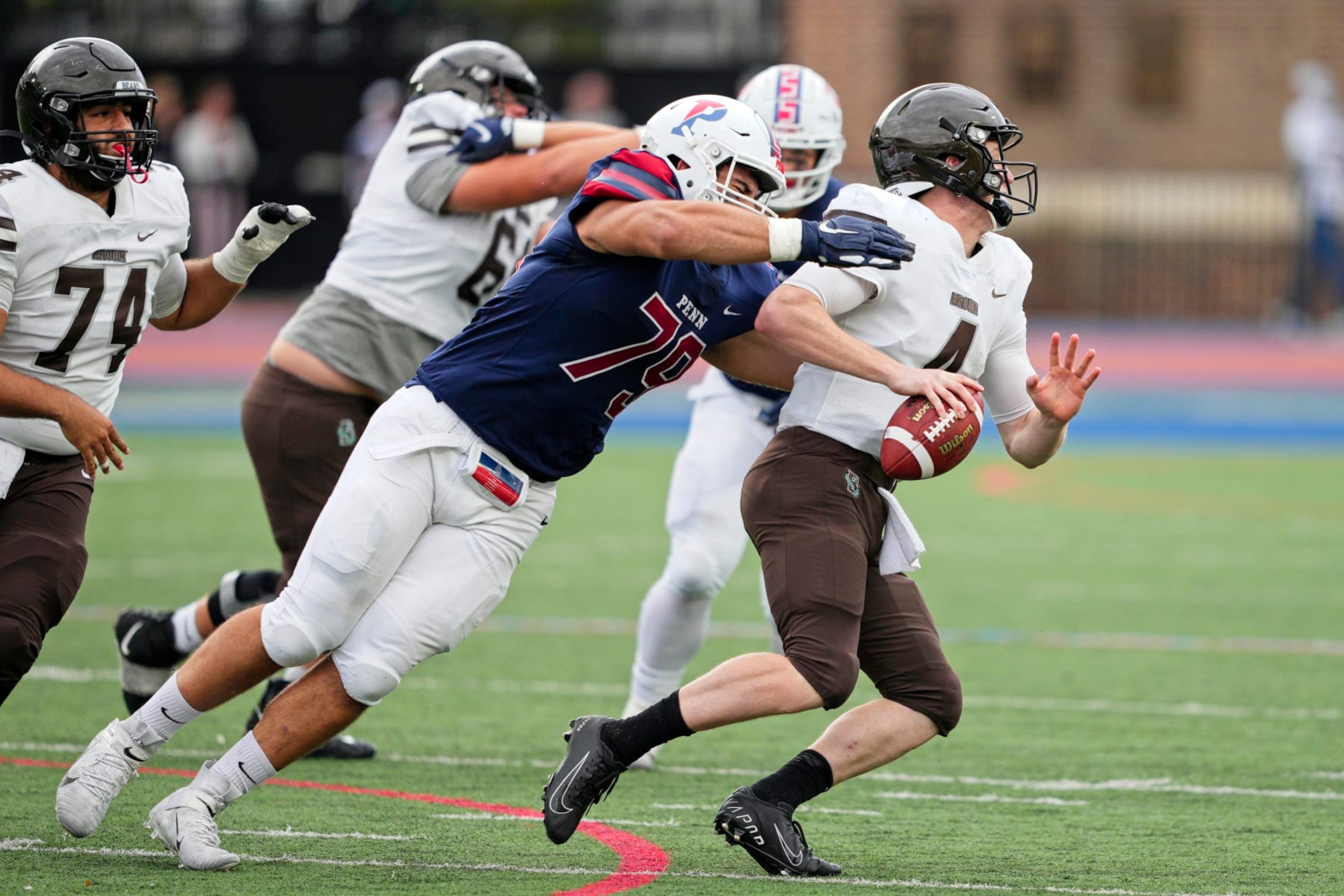 PHILADELPHIA, PA - OCTOBER 30: Pennsylvania Quakers defensive lineman Joey Slackman (79) sacks Brown Bears quarterback EJ Perry (4) during the game between the Pennsylvania Quakers and the Brown Bears on October 30, 2021 at Franklin Field in Philadelphia, PA. (Photo by Andy Lewis/Icon Sportswire via Getty Images)