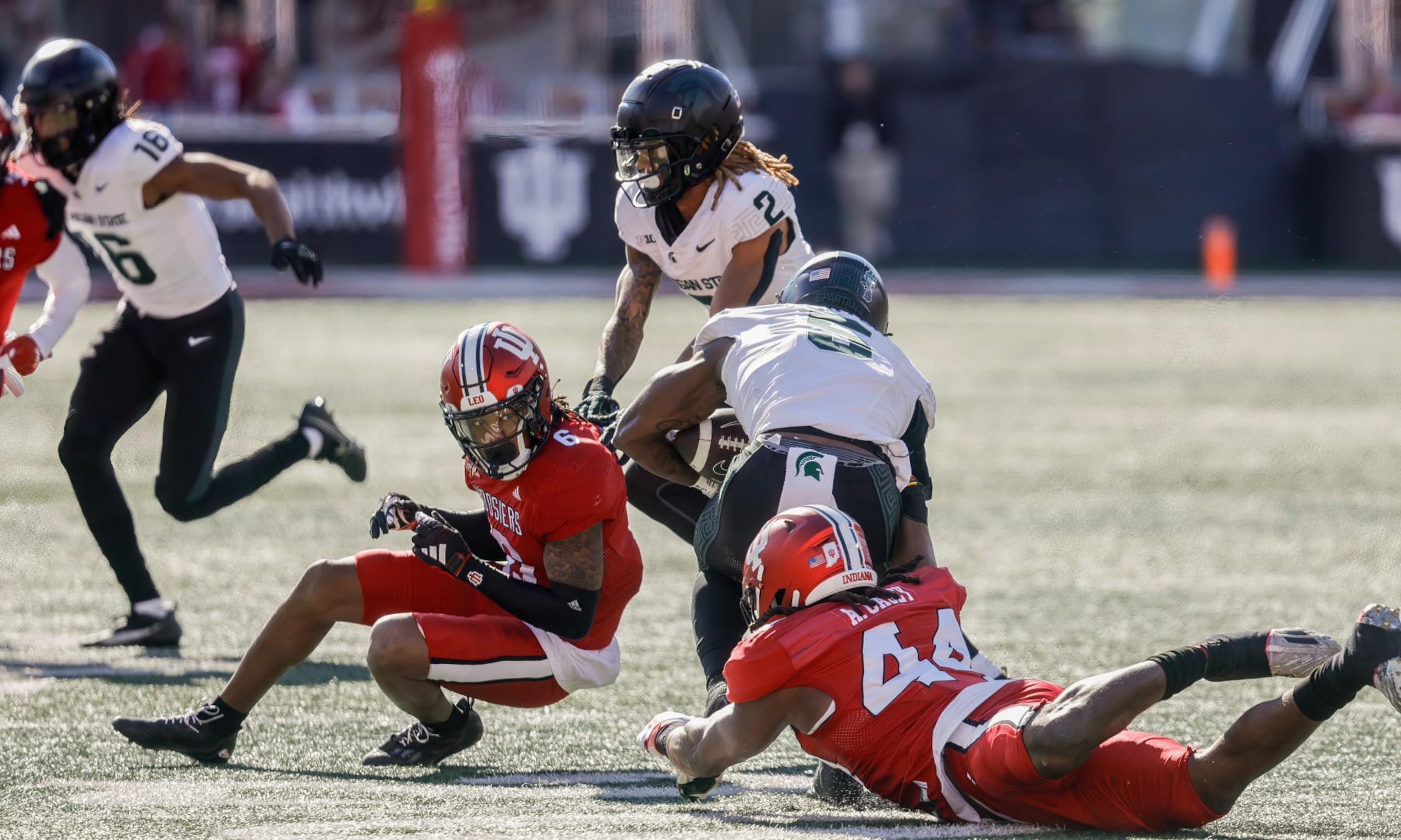 BLOOMINGTON, INDIANA, UNITED STATES - 2023/11/18: Indiana Hoosiers defensive back Phillip Dunnam (6) and Indiana Hoosiers linebacker Aaron Casey (44) tackle Michigan State Spartans tight end Maliq Carr (6) during an NCAA college football game in Bloomington. Indiana University lost to Michigan State 24-21. (Photo by Jeremy Hogan/SOPA Images/LightRocket via Getty Images)