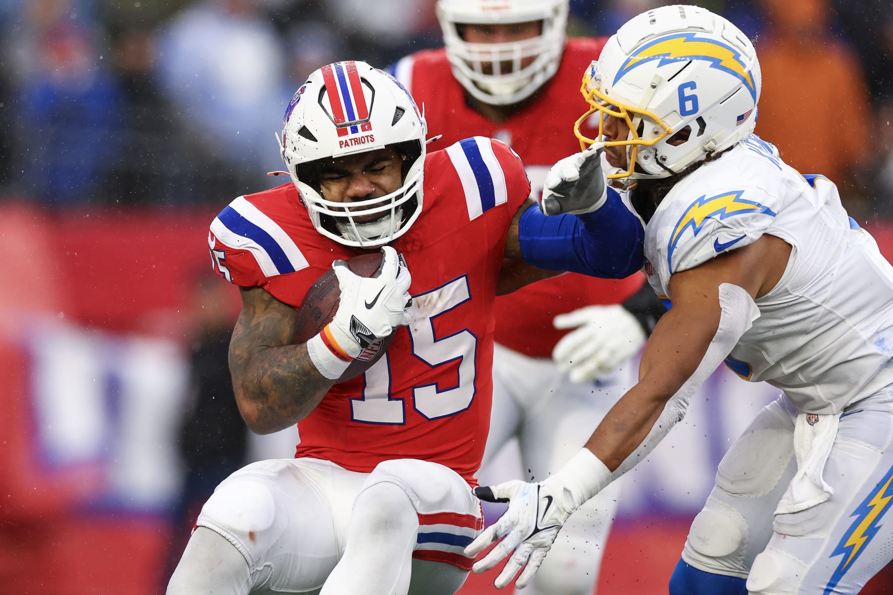 FOXBOROUGH, MASSACHUSETTS - DECEMBER 03: Ezekiel Elliott #15 of the New England Patriots runs with the ball while being tackled by Eric Kendricks #6 of the Los Angeles Chargers in the second quarter at Gillette Stadium on December 03, 2023 in Foxborough, Massachusetts. (Photo by Maddie Meyer/Getty Images)