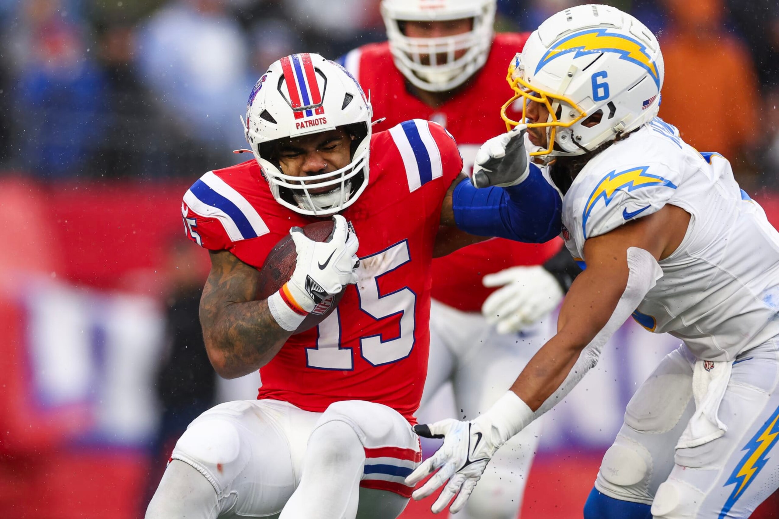 FOXBOROUGH, MASSACHUSETTS - DECEMBER 03: Ezekiel Elliott #15 of the New England Patriots runs with the ball while being tackled by Eric Kendricks #6 of the Los Angeles Chargers in the second quarter at Gillette Stadium on December 03, 2023 in Foxborough, Massachusetts. (Photo by Maddie Meyer/Getty Images) FOXBOROUGH, MASSACHUSETTS - DECEMBER 03: Ezekiel Elliott #15 of the New England Patriots runs with the ball while being tackled by Eric Kendricks #6 of the Los Angeles Chargers in the second quarter at Gillette Stadium on December 03, 2023 in Foxborough, Massachusetts. (Photo by Maddie Meyer/Getty Images)