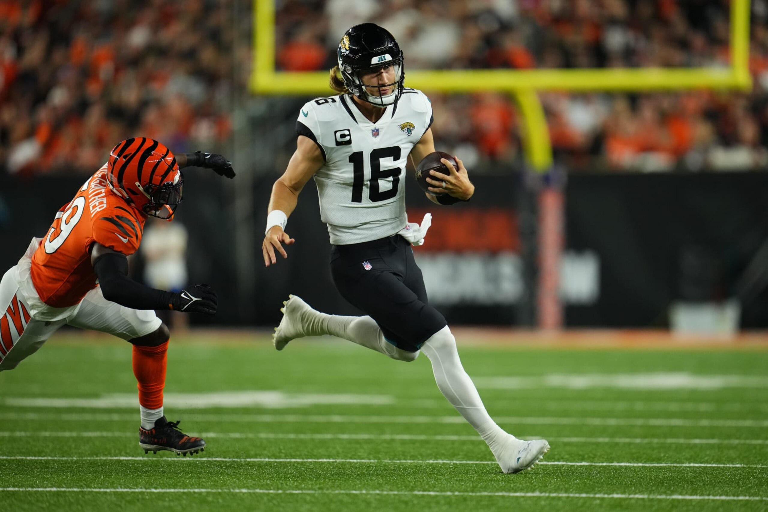 CINCINNATI, OHIO - SEPTEMBER 30: Trevor Lawrence #16 of the Jacksonville Jaguars runs the ball against the Cincinnati Bengals during an NFL game at Paul Brown Stadium on September 30, 2021 in Cincinnati, Ohio. (Photo by Cooper Neill/Getty Images)
