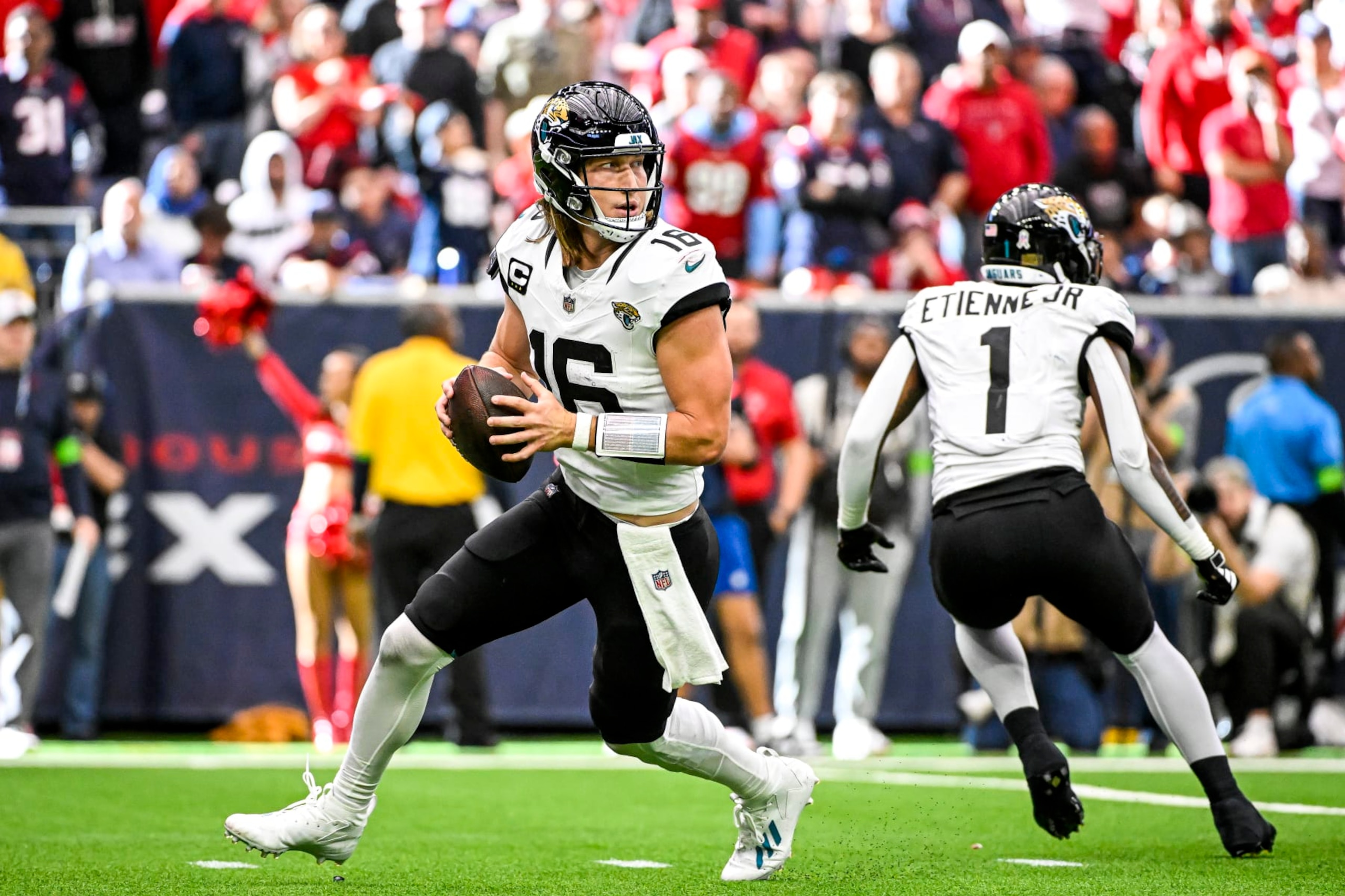 HOUSTON, TEXAS - NOVEMBER 26: Trevor Lawrence #16 of the Jacksonville Jaguars throws a pass against the Houston Texans at NRG Stadium on November 26, 2023 in Houston, Texas. (Photo by Logan Riely/Getty Images)