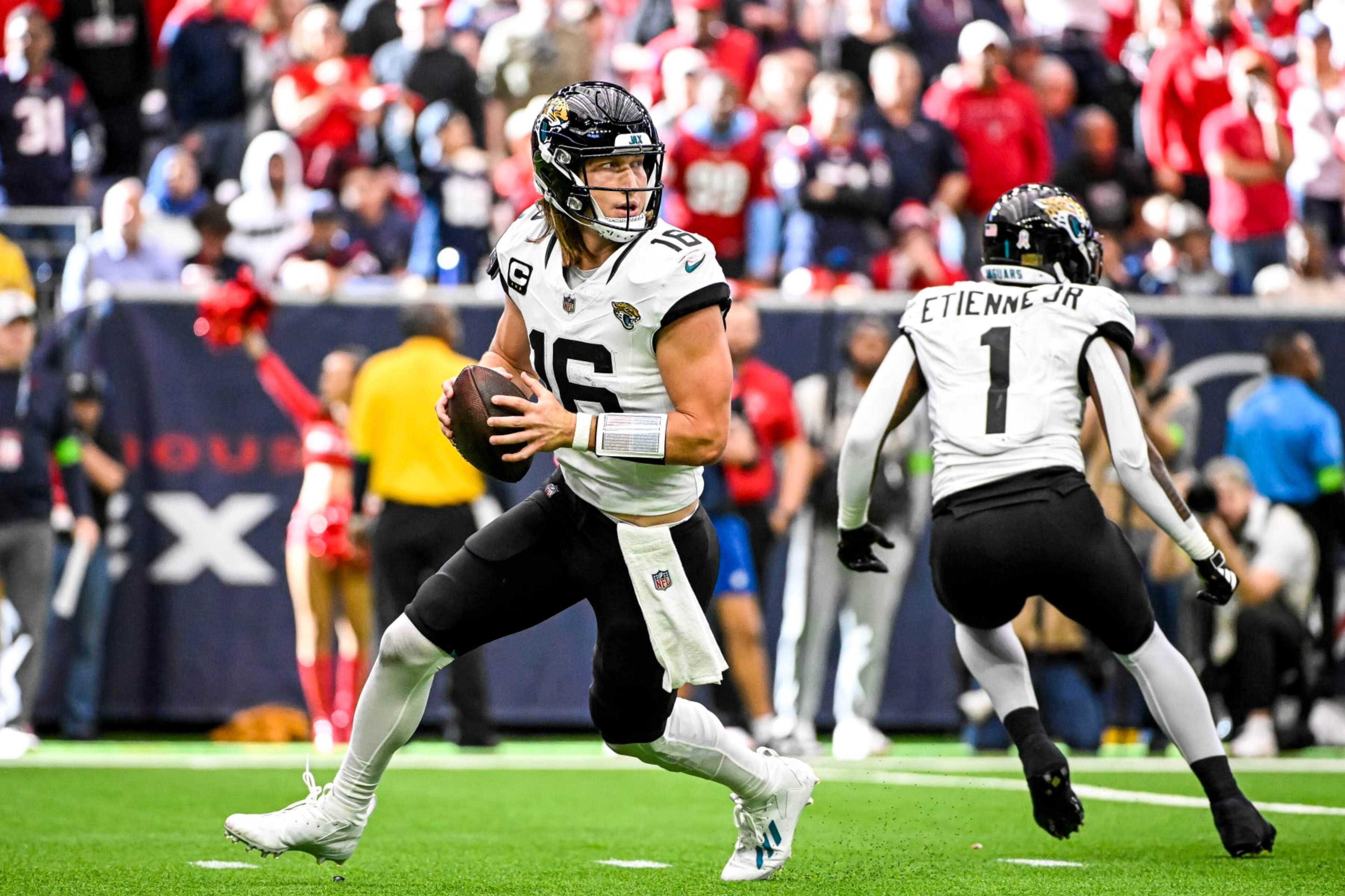 HOUSTON, TEXAS - NOVEMBER 26: Trevor Lawrence #16 of the Jacksonville Jaguars throws a pass against the Houston Texans at NRG Stadium on November 26, 2023 in Houston, Texas. (Photo by Logan Riely/Getty Images)