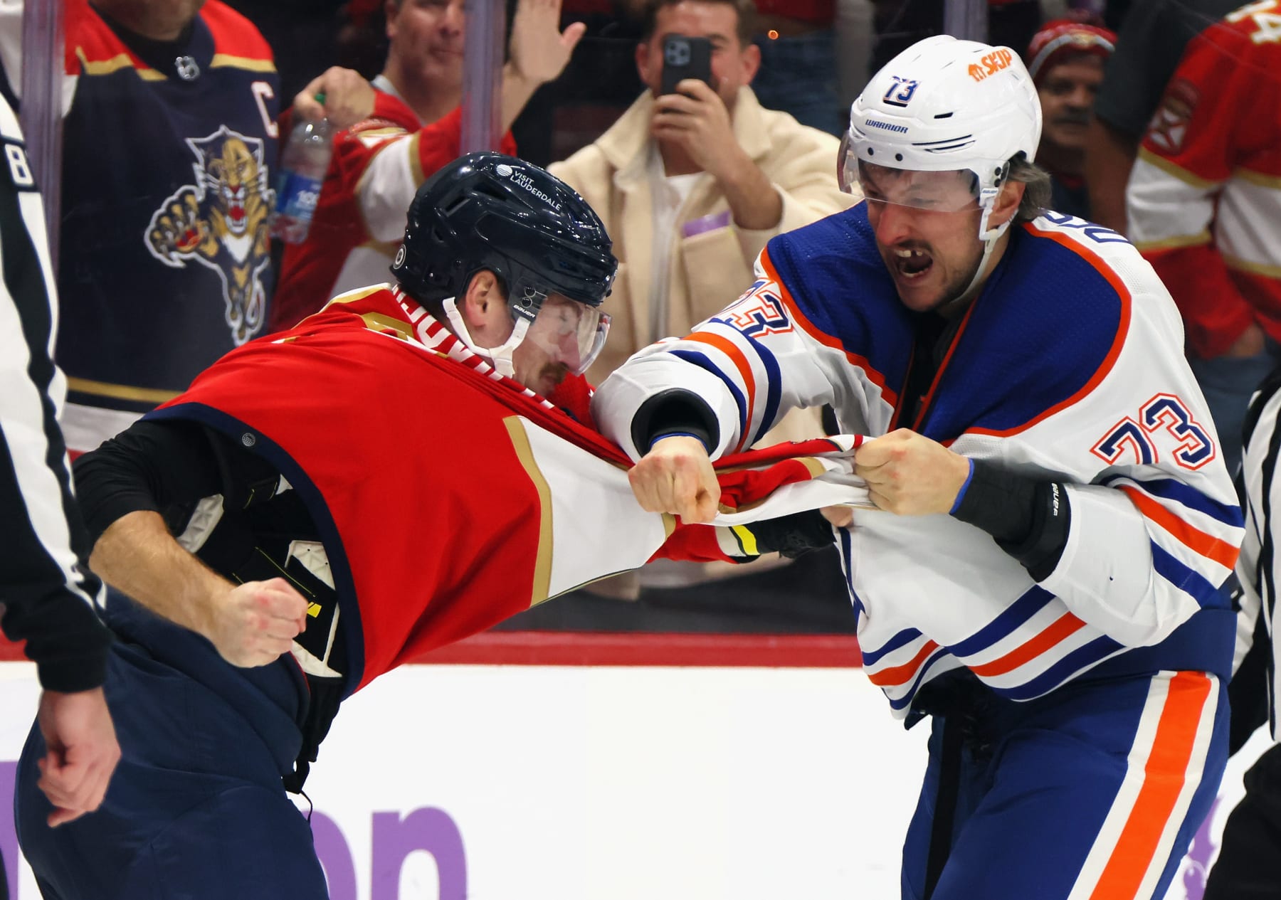 SUNRISE, FLORIDA - NOVEMBER 20: Vincent Desharnais #73 of the Edmonton Oilers and Jonah Gadjovich #12 of the Florida Panthers fight during the second period at Amerant Bank Arena on November 20, 2023 in Sunrise, Florida. (Photo by Bruce Bennett/Getty Images)