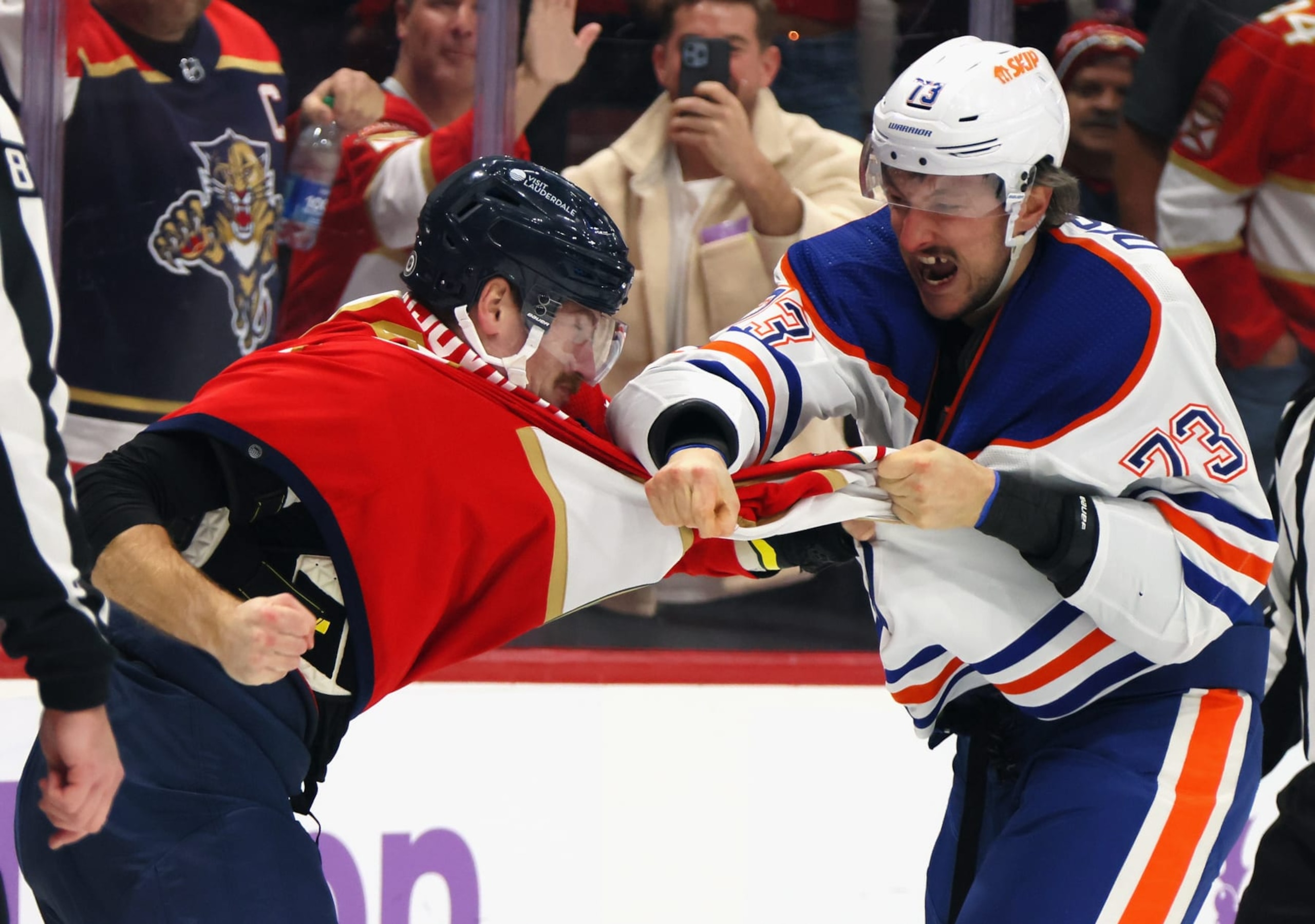 SUNRISE, FLORIDA - NOVEMBER 20: Vincent Desharnais #73 of the Edmonton Oilers and Jonah Gadjovich #12 of the Florida Panthers fight during the second period at Amerant Bank Arena on November 20, 2023 in Sunrise, Florida. (Photo by Bruce Bennett/Getty Images)