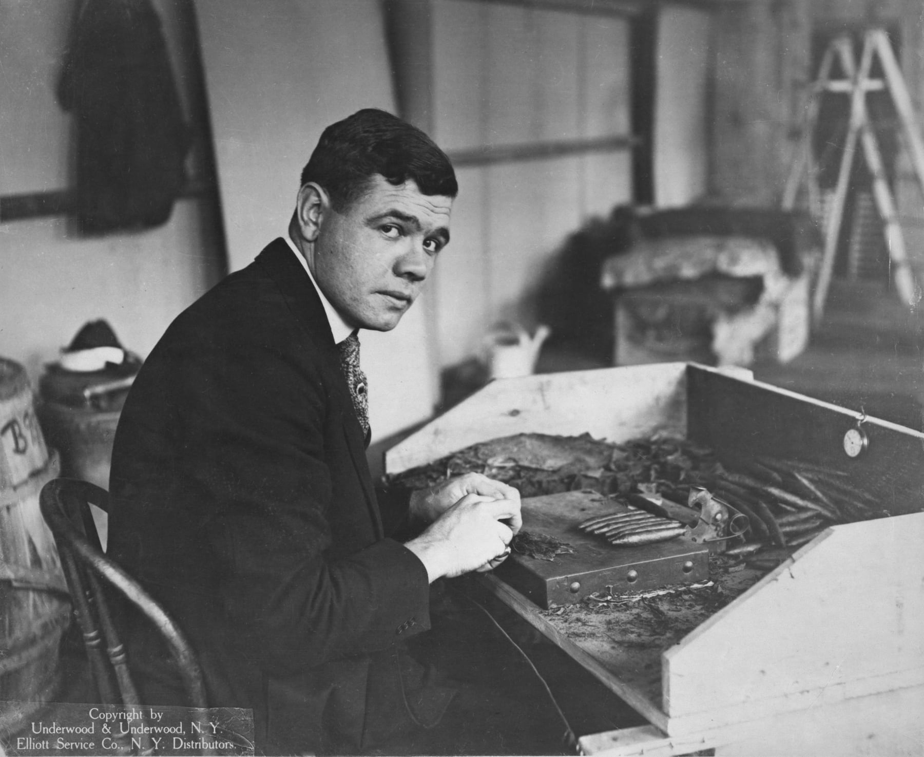 Baseball player Babe Ruth rolls a cigar on October 30, 1919: Original caption - The World's champion home-run slugger has entered the cigar manufacturing business and is learning it, as he learned baseball, from start to finish. He'll do in any box pitcher's box, batter's box or cigar box. Watch his smoke! (Photo by Underwood & Underwood/courtesy Library of Congress/Getty Images)