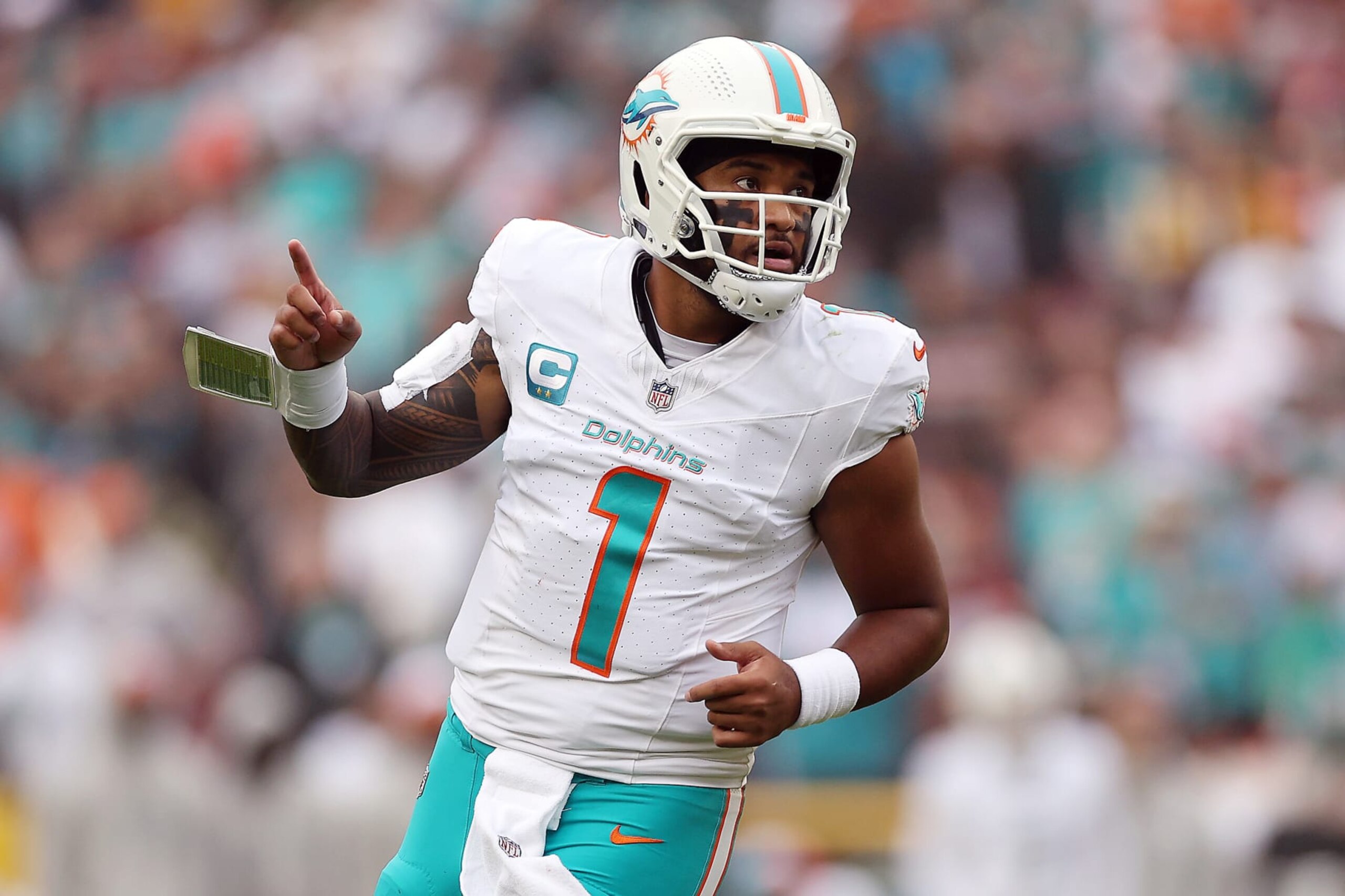 LANDOVER, MARYLAND - DECEMBER 03: Tua Tagovailoa #1 of the Miami Dolphins reacts after a play against the Washington Commanders during the second quarter of the game at FedExField on December 03, 2023 in Landover, Maryland. (Photo by Patrick Smith/Getty Images)