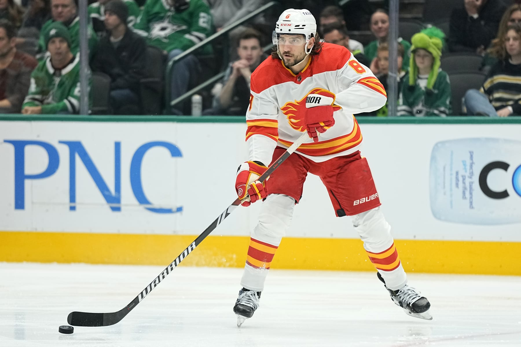 DALLAS, TEXAS - NOVEMBER 24: Chris Tanev #8 of the Calgary Flames passes the puck during the first period against the Dallas Stars at American Airlines Center on November 24, 2023 in Dallas, Texas. (Photo by Sam Hodde/Getty Images)