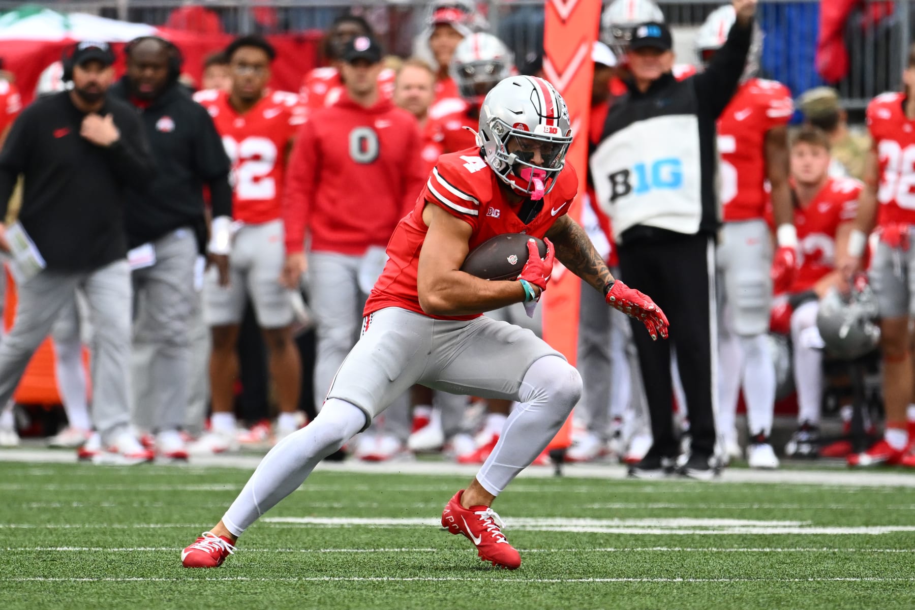 COLUMBUS, OHIO - OCTOBER 21: Julian Fleming #4 of the Ohio State Buckeyes runs with the ball during the third quarter of a game against the Penn State Nittany Lions at Ohio Stadium on October 21, 2023 in Columbus, Ohio. (Photo by Ben Jackson/Getty Images)