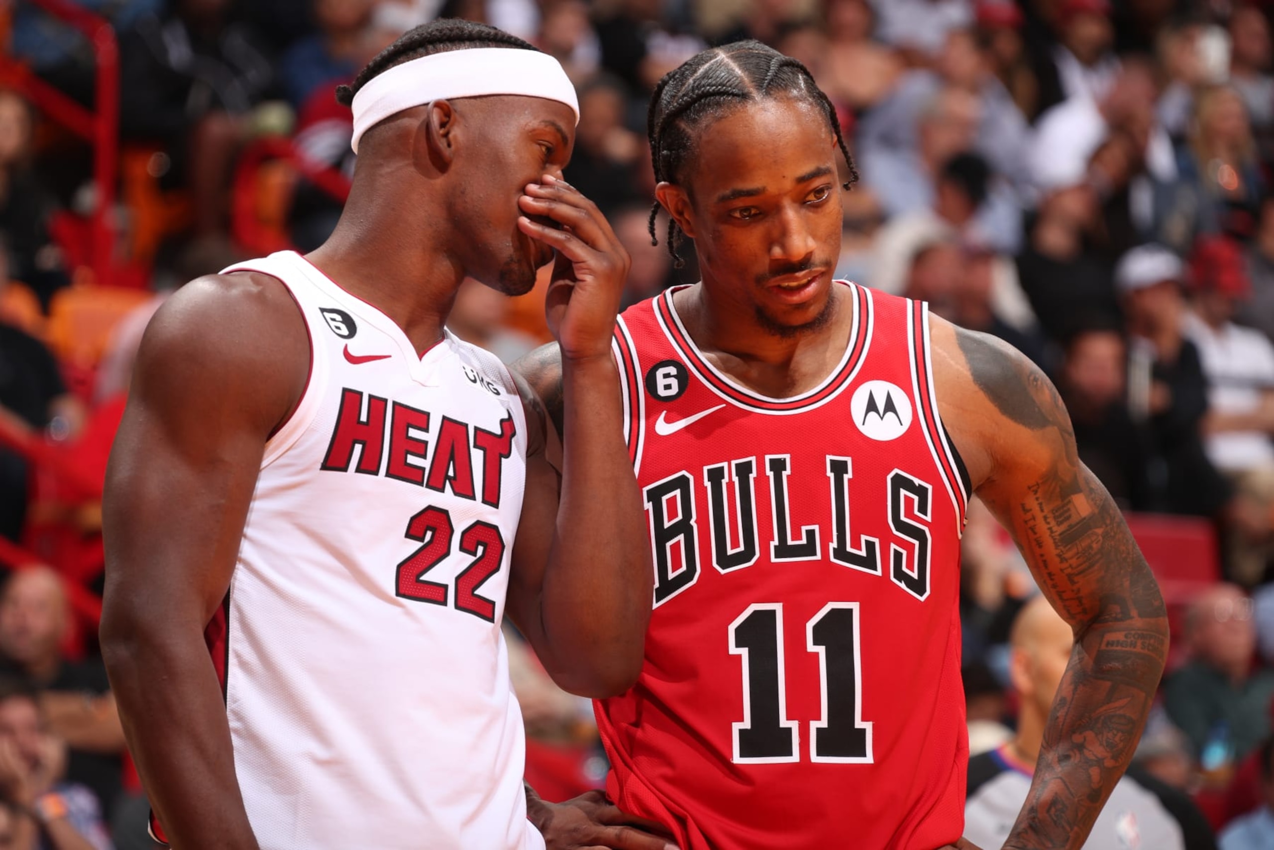 MIAMI, FL - OCTOBER 19: Jimmy Butler #22 of the Miami Heat and DeMar DeRozan #11 of the Chicago Bulls talk on the court during the season opener game on October 19, 2022 at FTX Arena in Miami, Florida. NOTE TO USER: User expressly acknowledges and agrees that, by downloading and or using this Photograph, user is consenting to the terms and conditions of the Getty Images License Agreement. Mandatory Copyright Notice: Copyright 2022 NBAE (Photo by Issac Baldizon/NBAE via Getty Images)