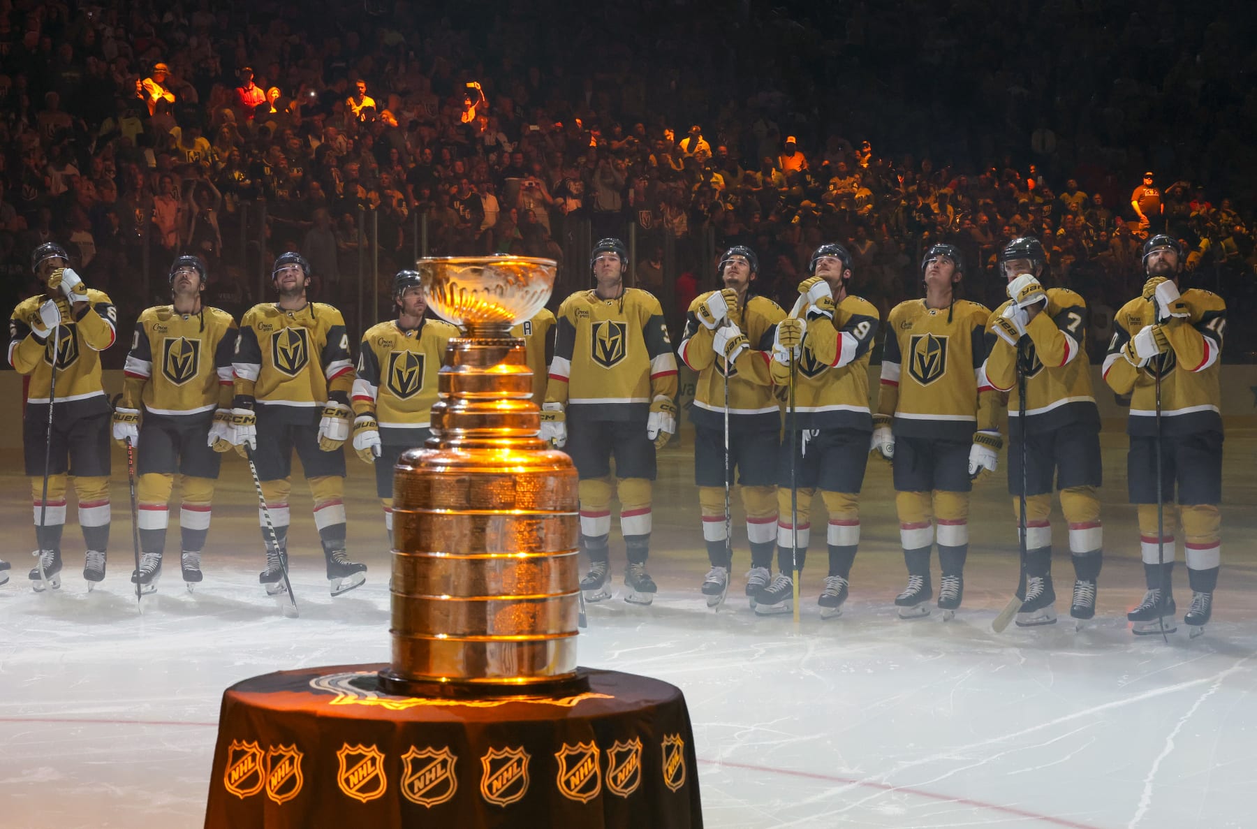 LAS VEGAS, NEVADA - OCTOBER 10: The Stanley Cup is displayed as (L-R) Keegan Kolesar #55, Chandler Stephenson #20 Paul Cotter #43, Jonathan Marchessault #81, Brayden McNabb #3, Brett Howden #21, Jack Eichel #9, Zach Whitecloud #2, Alex Pietrangelo #7 and Nicolas Roy #10 of the Vegas Golden Knights watch the 2023 Stanley Cup championship banner being raised during a ceremony before the team's home opener against the Seattle Kraken at T-Mobile Arena on October 10, 2023 in Las Vegas, Nevada. The Golden Knights defeated the Kraken 4-1. (Photo by Ethan Miller/Getty Images)