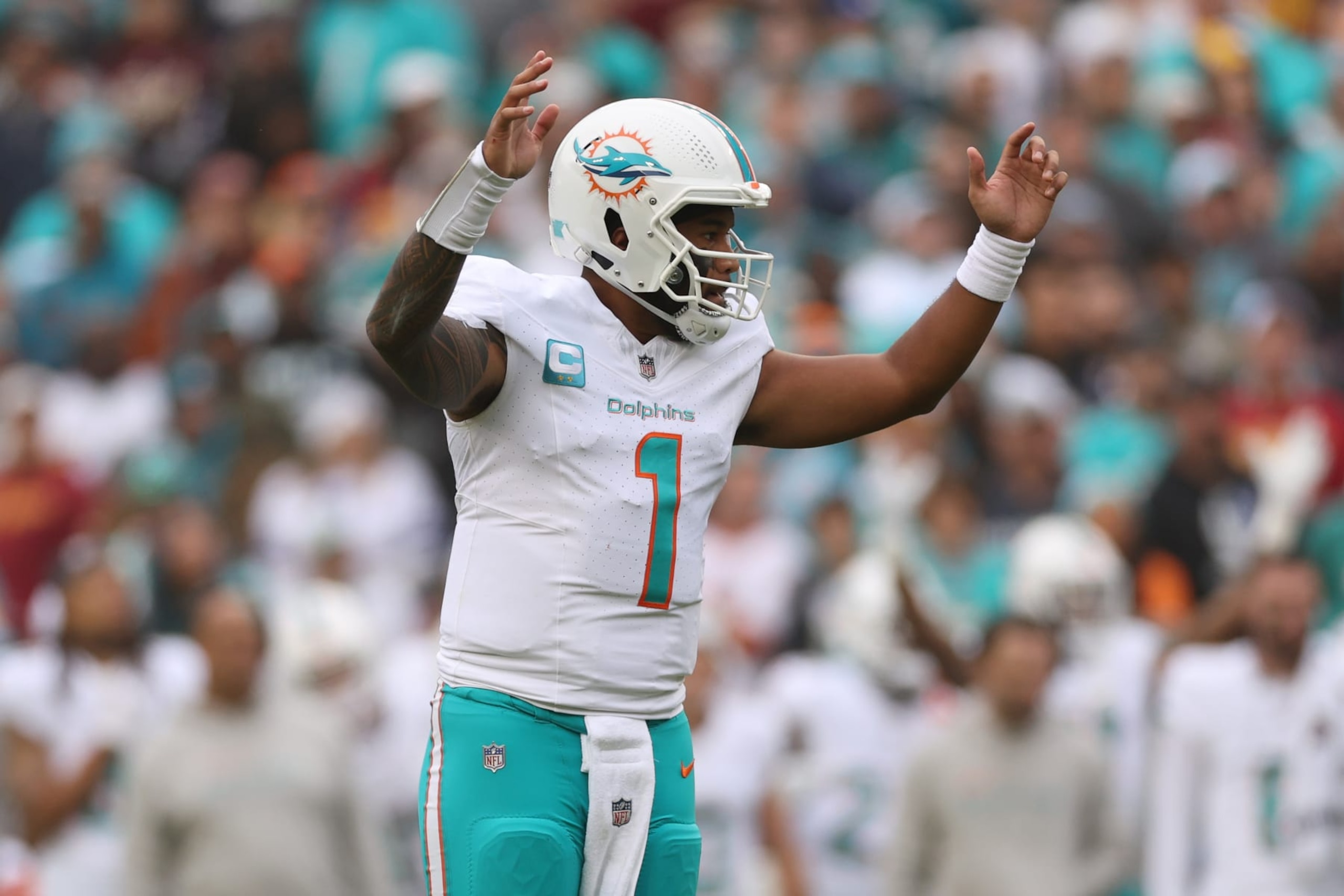 LANDOVER, MARYLAND - DECEMBER 03: Quarerback Tua Tagovailoa #1 of the Miami Dolphins celebrates a touchdown against the Washington Commanders during the second quarter at FedExField on December 03, 2023 in Landover, Maryland. (Photo by Patrick Smith/Getty Images)