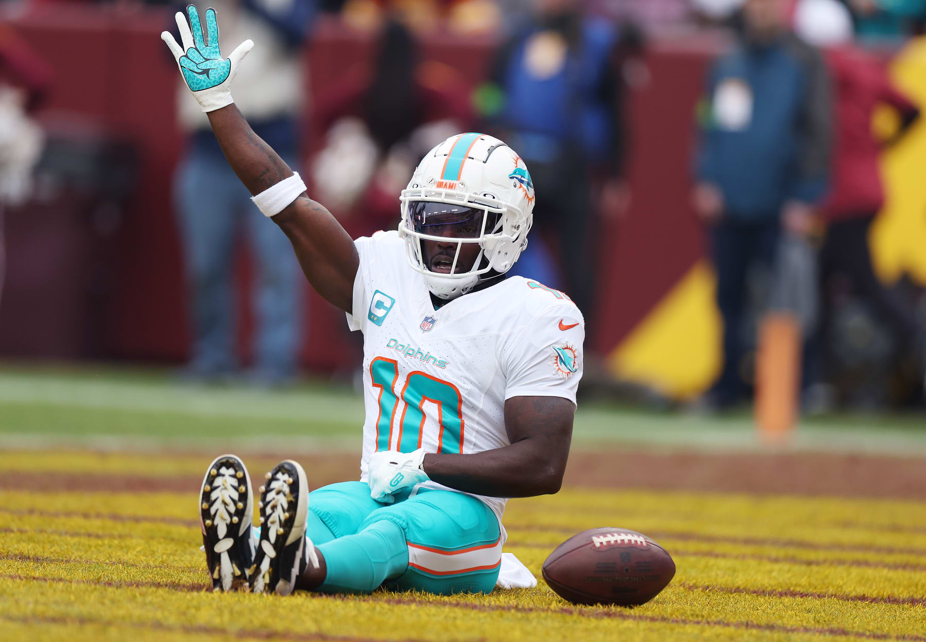 LANDOVER, MARYLAND - DECEMBER 03: Tyreek Hill #10 of the Miami Dolphins celebrates after scoring a touchdown against the Washington Commanders during the first quarter of the game at FedExField on December 03, 2023 in Landover, Maryland. (Photo by Rob Carr/Getty Images)