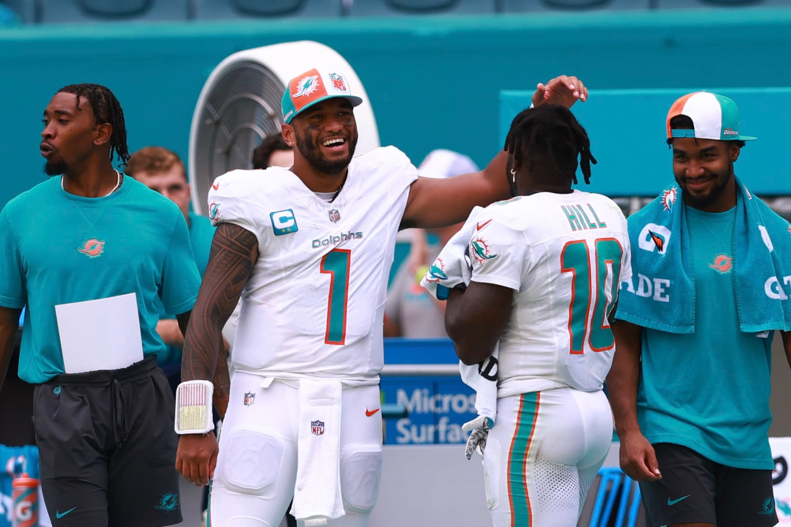 MIAMI GARDENS, FLORIDA - SEPTEMBER 24: Tua Tagovailoa #1 of the Miami Dolphins celebrates with Tyreek Hill #10 of the Miami Dolphins during the fourth quarter against the Denver Broncos at Hard Rock Stadium on September 24, 2023 in Miami Gardens, Florida. (Photo by Megan Briggs/Getty Images)