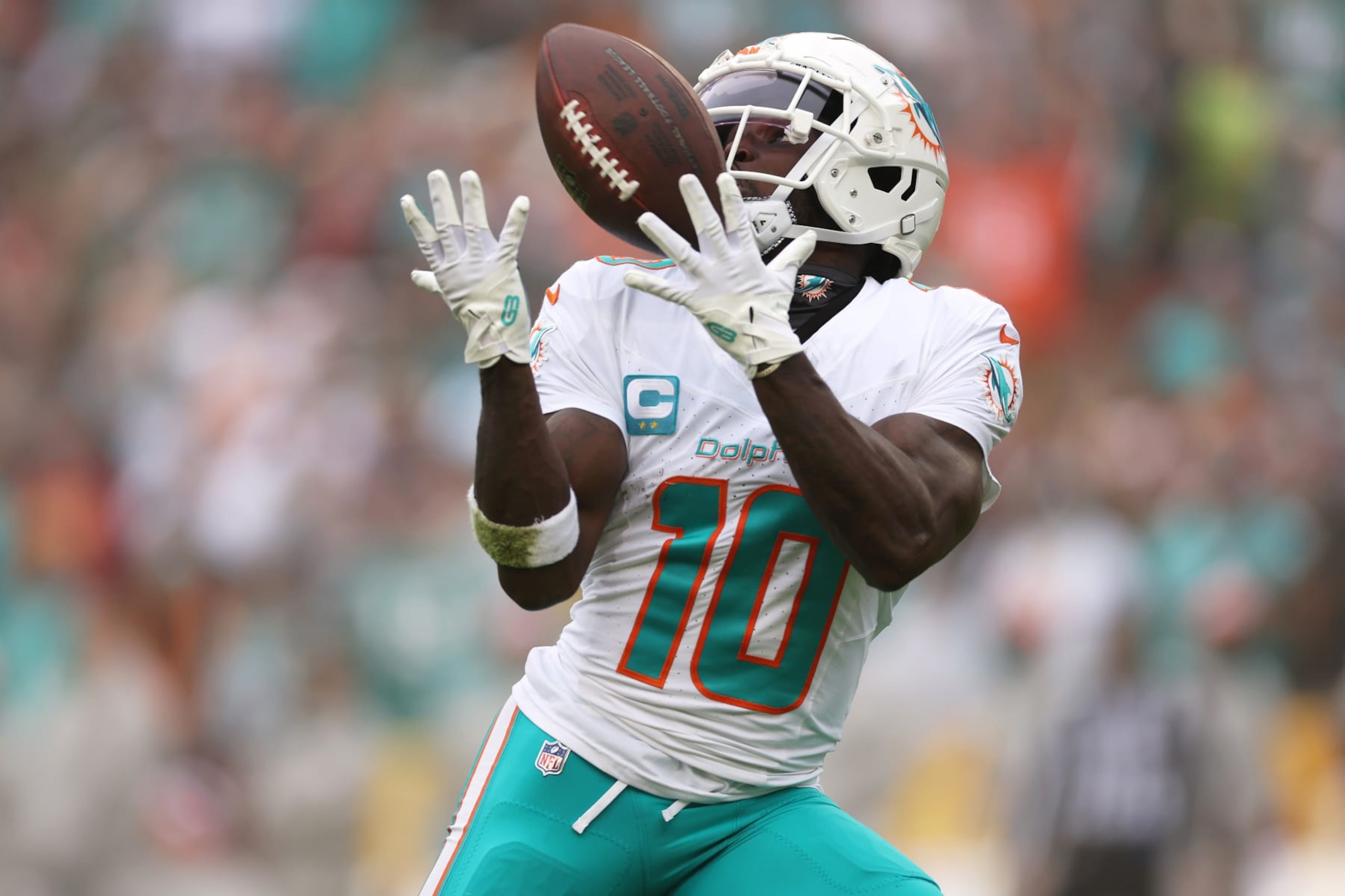 LANDOVER, MARYLAND - DECEMBER 03: Tyreek Hill #10 of the Miami Dolphins catches a pass for a touchdown against the Washington Commanders during the second quarter of the game at FedExField on December 03, 2023 in Landover, Maryland. (Photo by Patrick Smith/Getty Images)