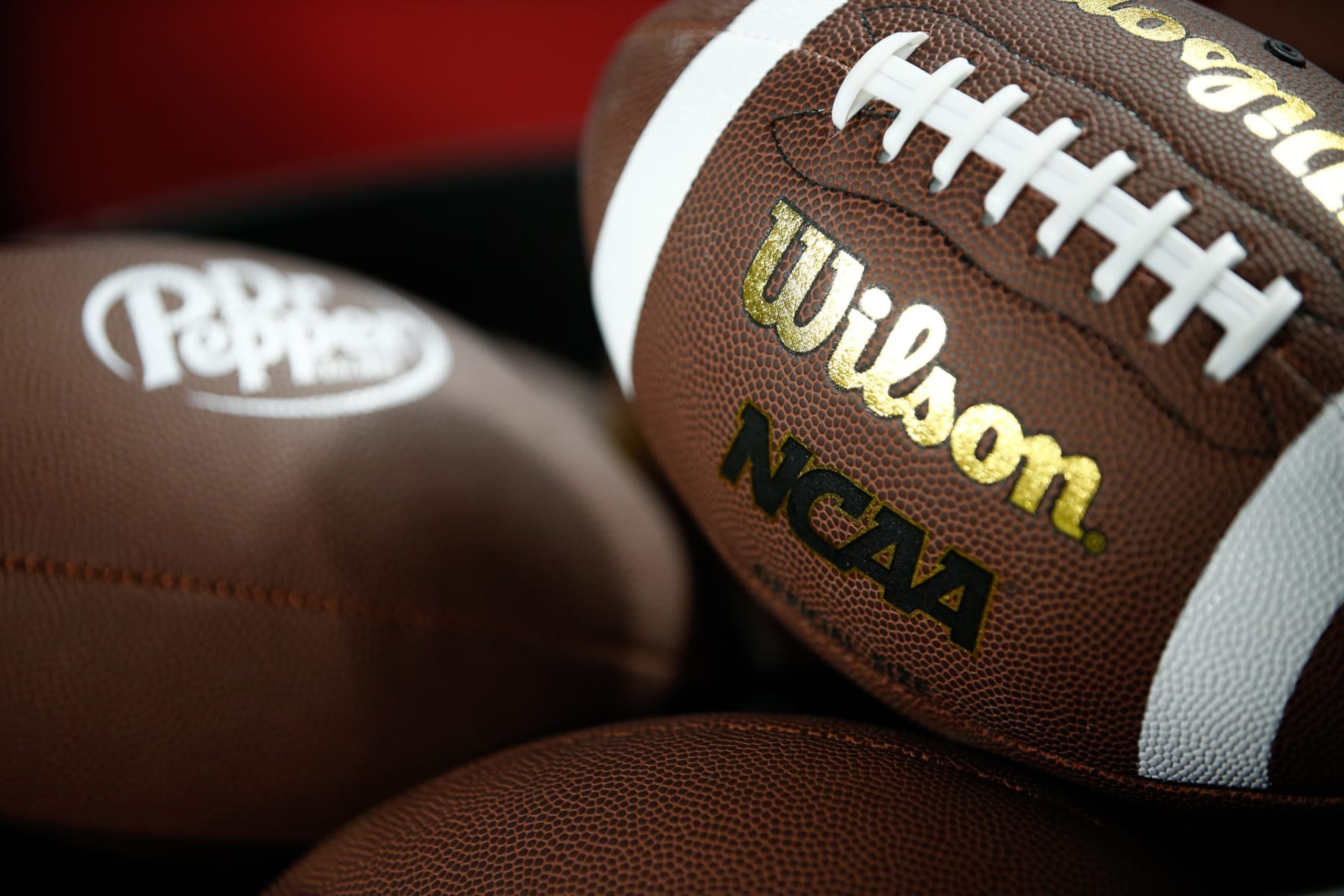 CHARLOTTE, NORTH CAROLINA - DECEMBER 2: The Wilson and NCAA Logo is shown on a football as the Louisville Cardinals take on the Florida State Seminoles during the ACC Championship at Bank of America Stadium on December 2, 2023 in Charlotte, North Carolina. (Photo by Isaiah Vazquez/Getty Images) CHARLOTTE, NORTH CAROLINA - DECEMBER 2: The Wilson and NCAA Logo is shown on a football as the Louisville Cardinals take on the Florida State Seminoles during the ACC Championship at Bank of America Stadium on December 2, 2023 in Charlotte, North Carolina. (Photo by Isaiah Vazquez/Getty Images)