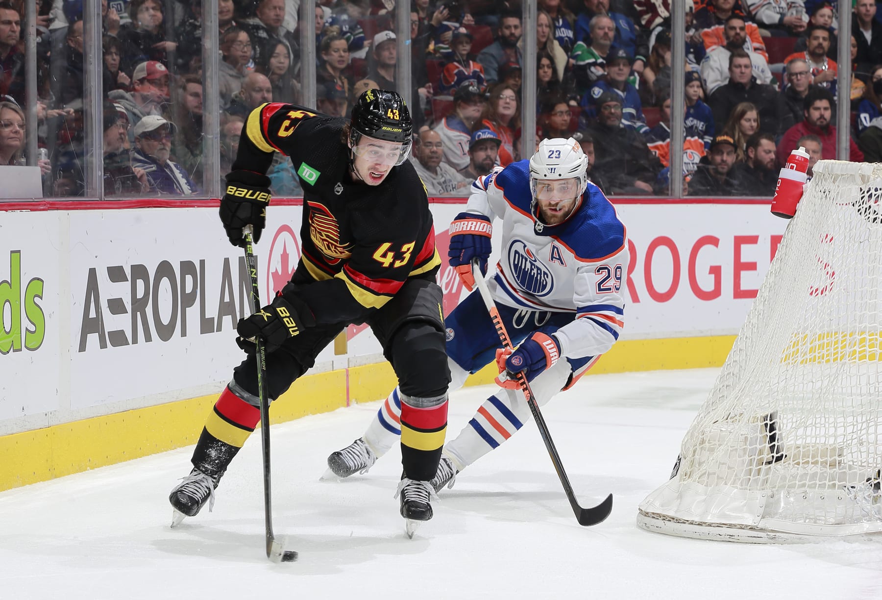 Vancouver Canucks defenseman Quinn Hughes (left) and Edmonton Oilers forward Leon Draisaitl 