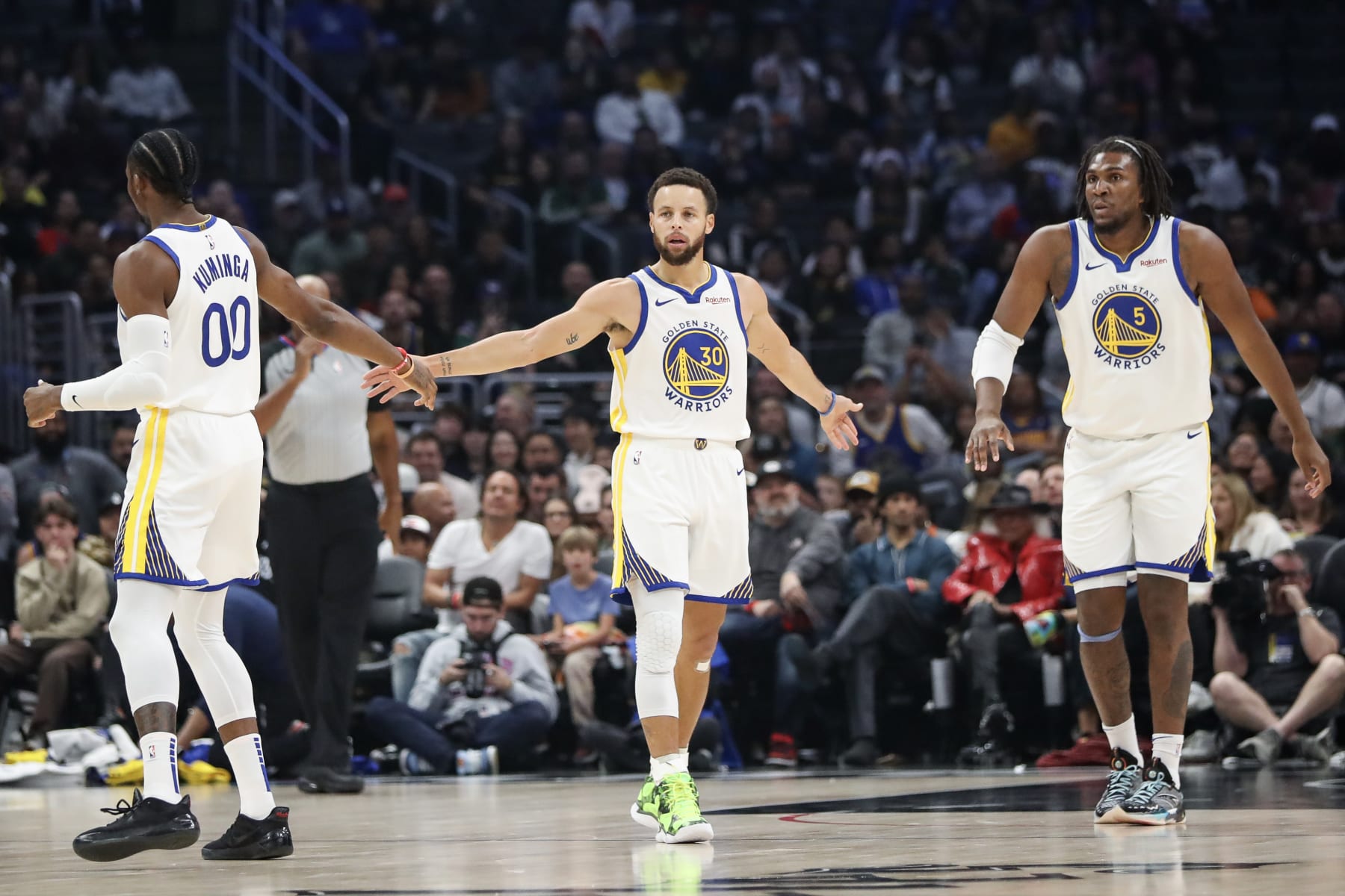 Jonathan Kuminga, Stephen Curry and Kevon Looney