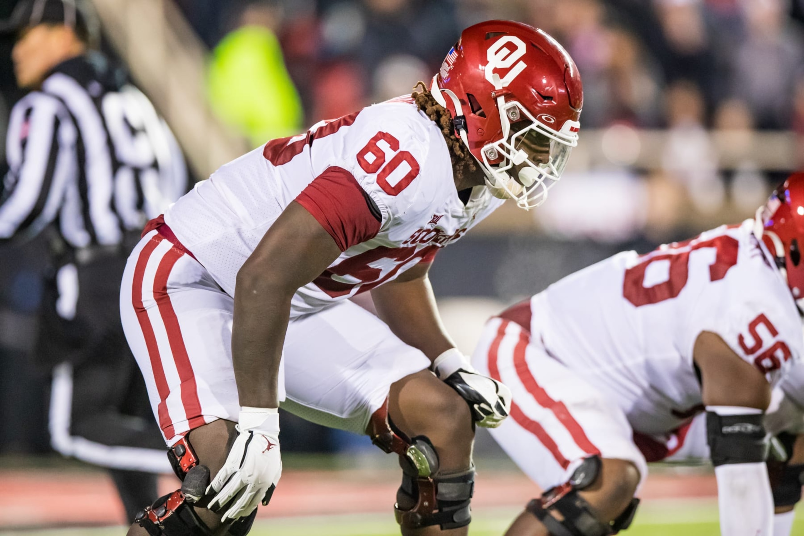 LUBBOCK, TEXAS - NOVEMBER 26: Offensive lineman Tyler Guyton #60 of the Oklahoma Sooners lines up during the first half against the Texas Tech Red Raiders at Jones AT&T Stadium on November 26, 2022 in Lubbock, Texas. (Photo by John E. Moore III/Getty Images)