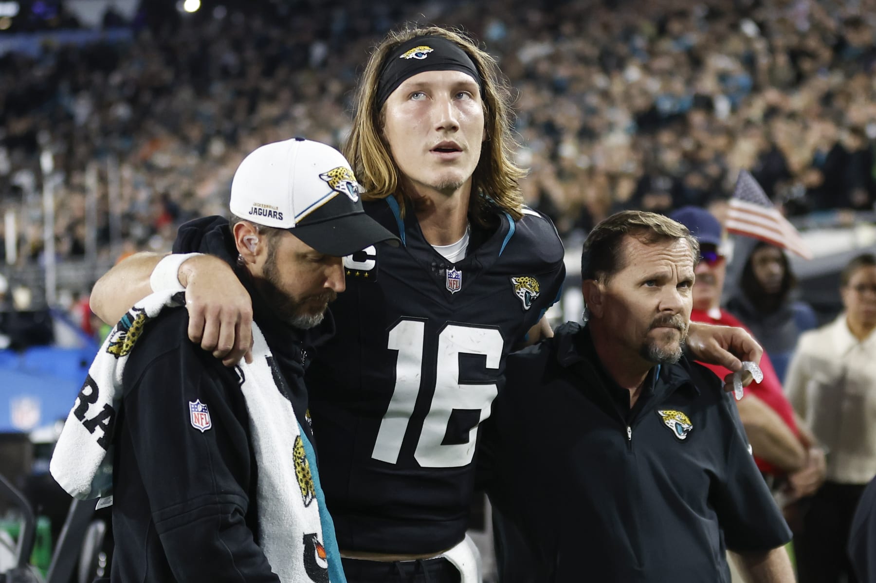 JACKSONVILLE, FL - DECEMBER 04: Jacksonville Jaguars quarterback Trevor Lawrence (16) is helped off the field by training staff during the game between the Jacksonville Jaguars and the Cincinnati Bengals on December 4, 2023 at EverBank Stadium in Jacksonville, Fl. (Photo by David Rosenblum/Icon Sportswire via Getty Images)