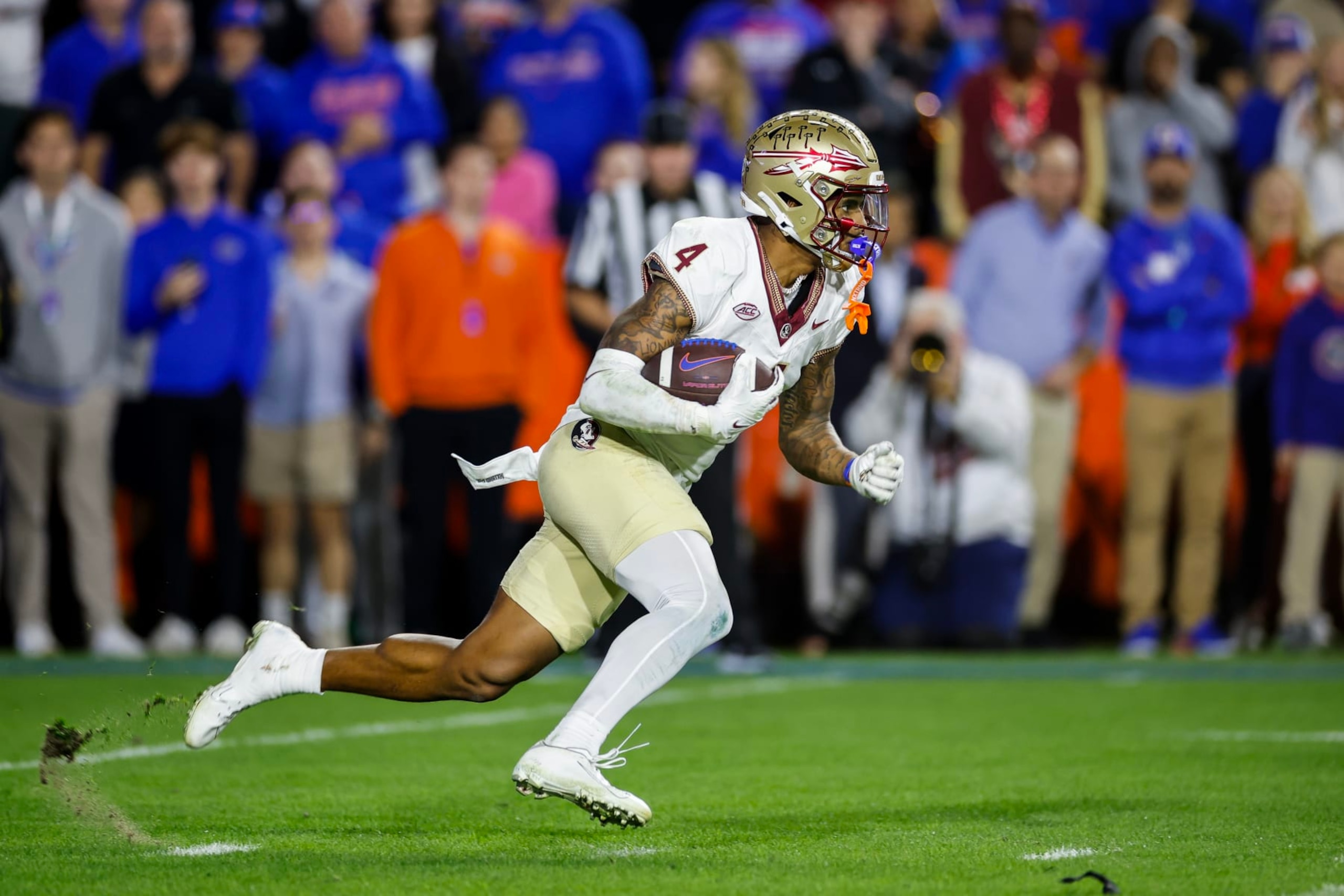 GAINESVILLE, FLORIDA - NOVEMBER 25: Keon Coleman #4 of the Florida State Seminoles runs with the ball  during the second half of a game against the Florida Gators at Ben Hill Griffin Stadium on November 25, 2023 in Gainesville, Florida. (Photo by James Gilbert/Getty Images)