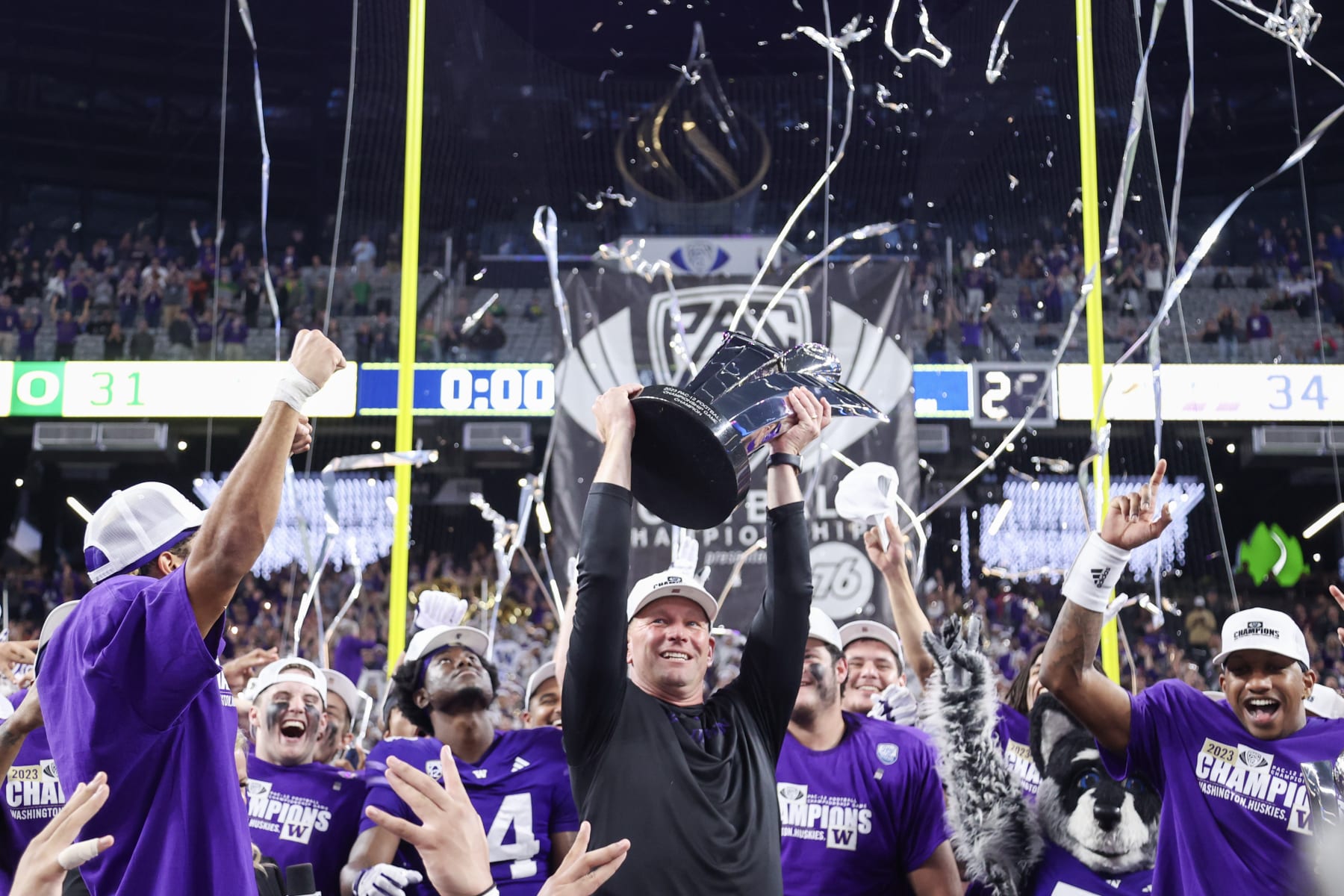 LAS VEGAS, NEVADA - DECEMBER 01: Head coach Kalen DeBoer of the Washington Huskies celebrates with his team while lifting the Pac-12 Championship trophy after his team's 34-31 win against the Oregon Ducks during the Pac-12 Championship at Allegiant Stadium on December 01, 2023 in Las Vegas, Nevada. (Photo by Ian Maule/Getty Images)