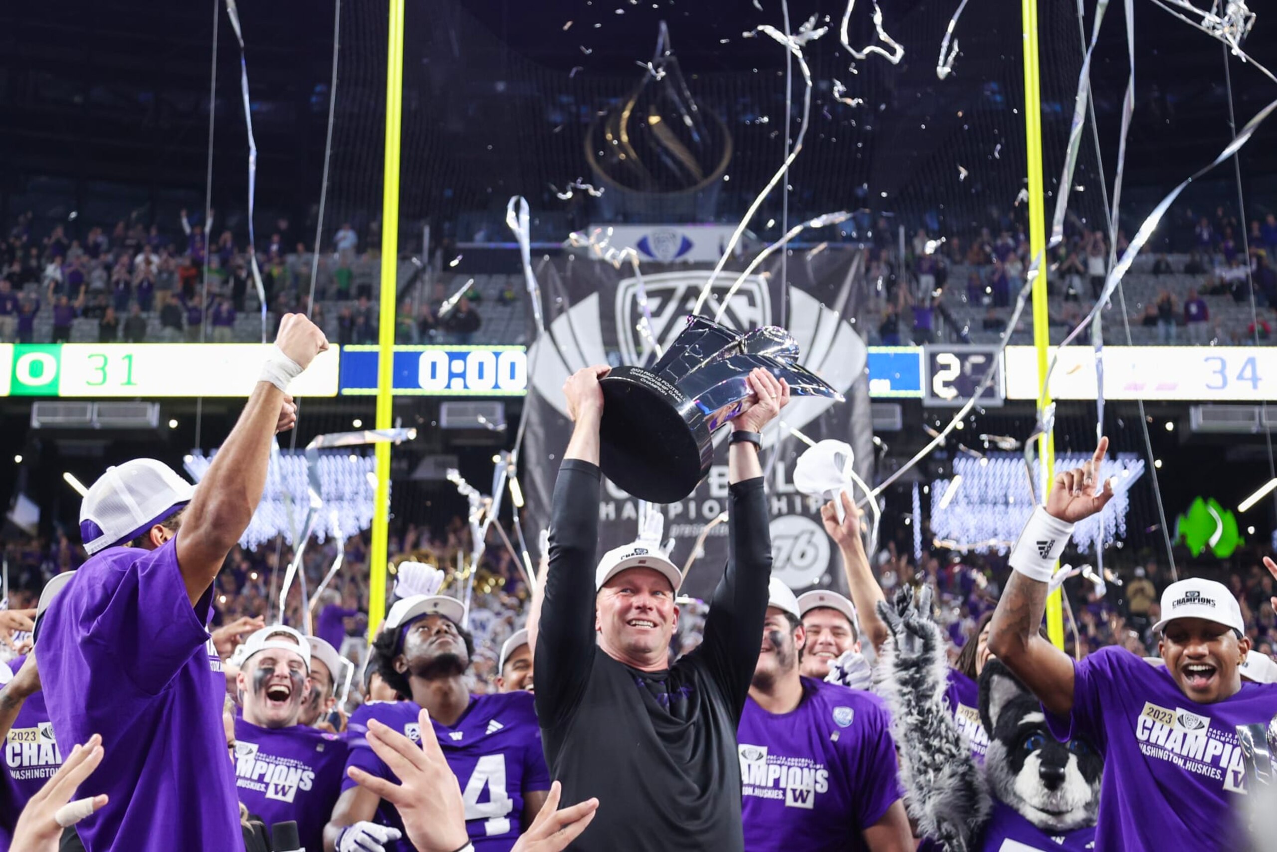 LAS VEGAS, NEVADA - DECEMBER 01: Head coach Kalen DeBoer of the Washington Huskies celebrates with his team while lifting the Pac-12 Championship trophy after his team's 34-31 win against the Oregon Ducks during the Pac-12 Championship at Allegiant Stadium on December 01, 2023 in Las Vegas, Nevada. (Photo by Ian Maule/Getty Images) LAS VEGAS, NEVADA - DECEMBER 01: Head coach Kalen DeBoer of the Washington Huskies celebrates with his team while lifting the Pac-12 Championship trophy after his team's 34-31 win against the Oregon Ducks during the Pac-12 Championship at Allegiant Stadium on December 01, 2023 in Las Vegas, Nevada. (Photo by Ian Maule/Getty Images)