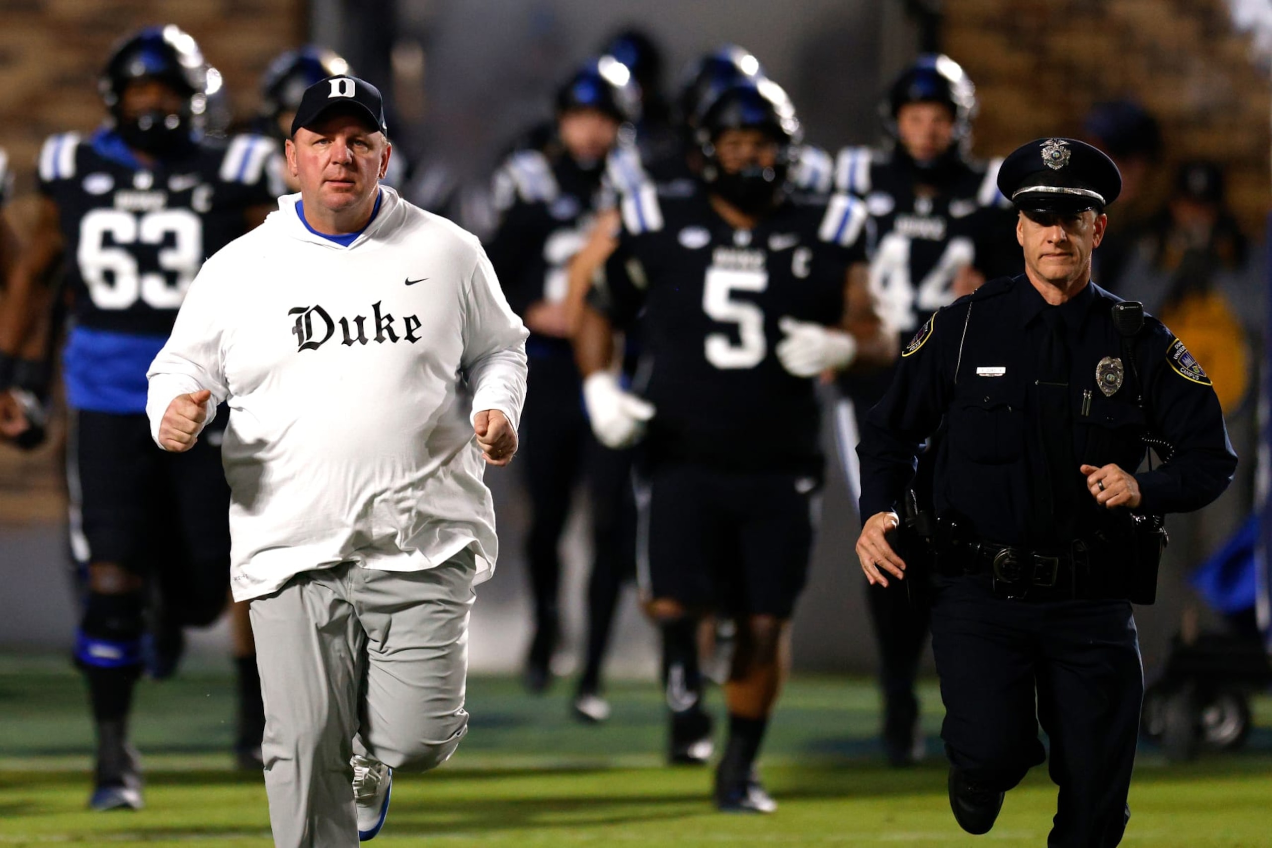 DURHAM, NORTH CAROLINA - NOVEMBER 2: Head coach Mike Elko of the Duke Blue Devils leads his team onto the field prior to the game against the Wake Forest Demon Deacons at Wallace Wade Stadium on November 2, 2023 in Durham, North Carolina. Duke won 24-21. (Photo by Lance King/Getty Images)