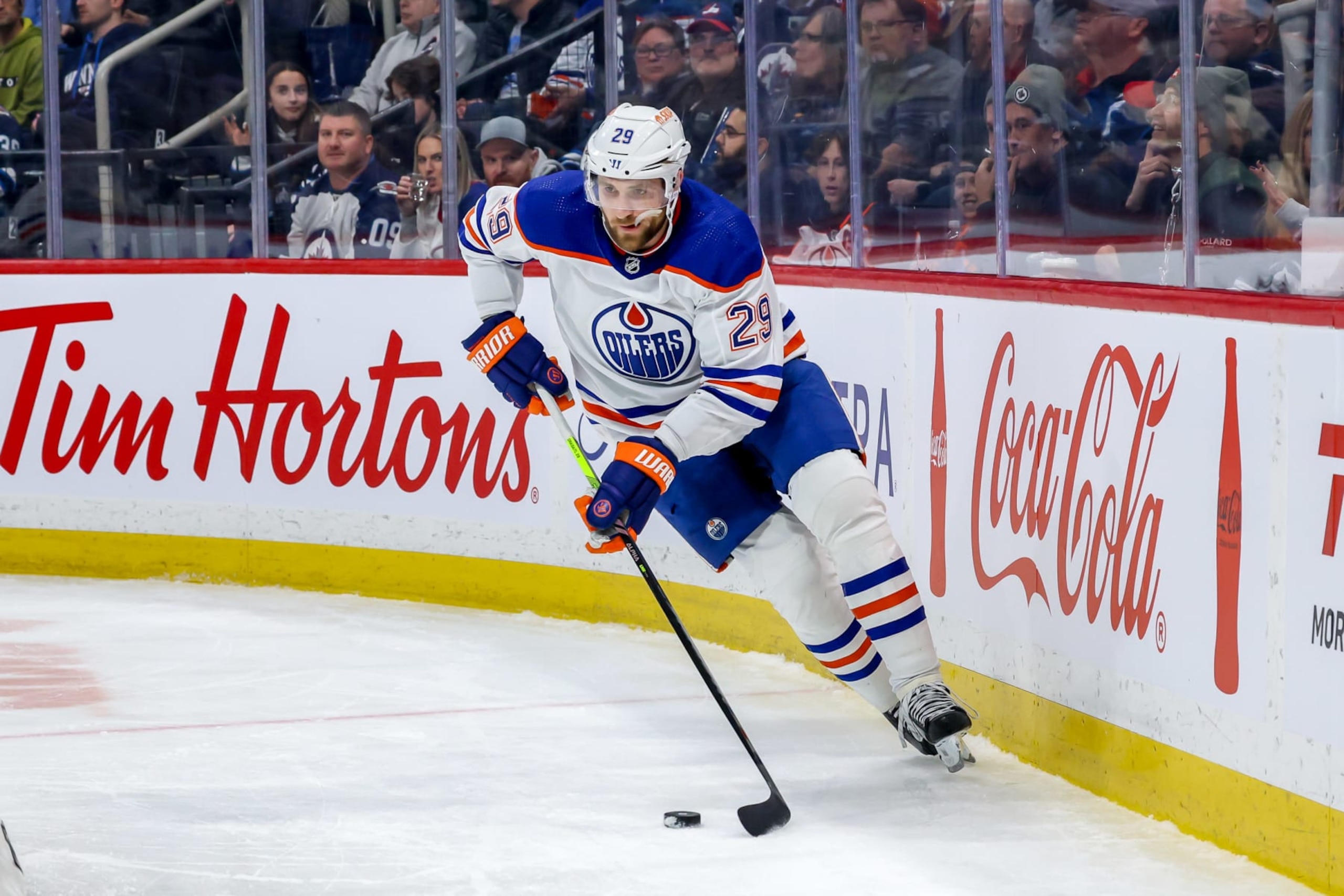 WINNIPEG, CANADA - NOVEMBER 30: Leon Draisaitl #29 of the Edmonton Oilers plays the puck along the boards during second period action against the Winnipeg Jets at the Canada Life Centre on November 30, 2023 in Winnipeg, Manitoba, Canada. (Photo by Jonathan Kozub/NHLI via Getty Images) WINNIPEG, CANADA - NOVEMBER 30: Leon Draisaitl #29 of the Edmonton Oilers plays the puck along the boards during second period action against the Winnipeg Jets at the Canada Life Centre on November 30, 2023 in Winnipeg, Manitoba, Canada. (Photo by Jonathan Kozub/NHLI via Getty Images)