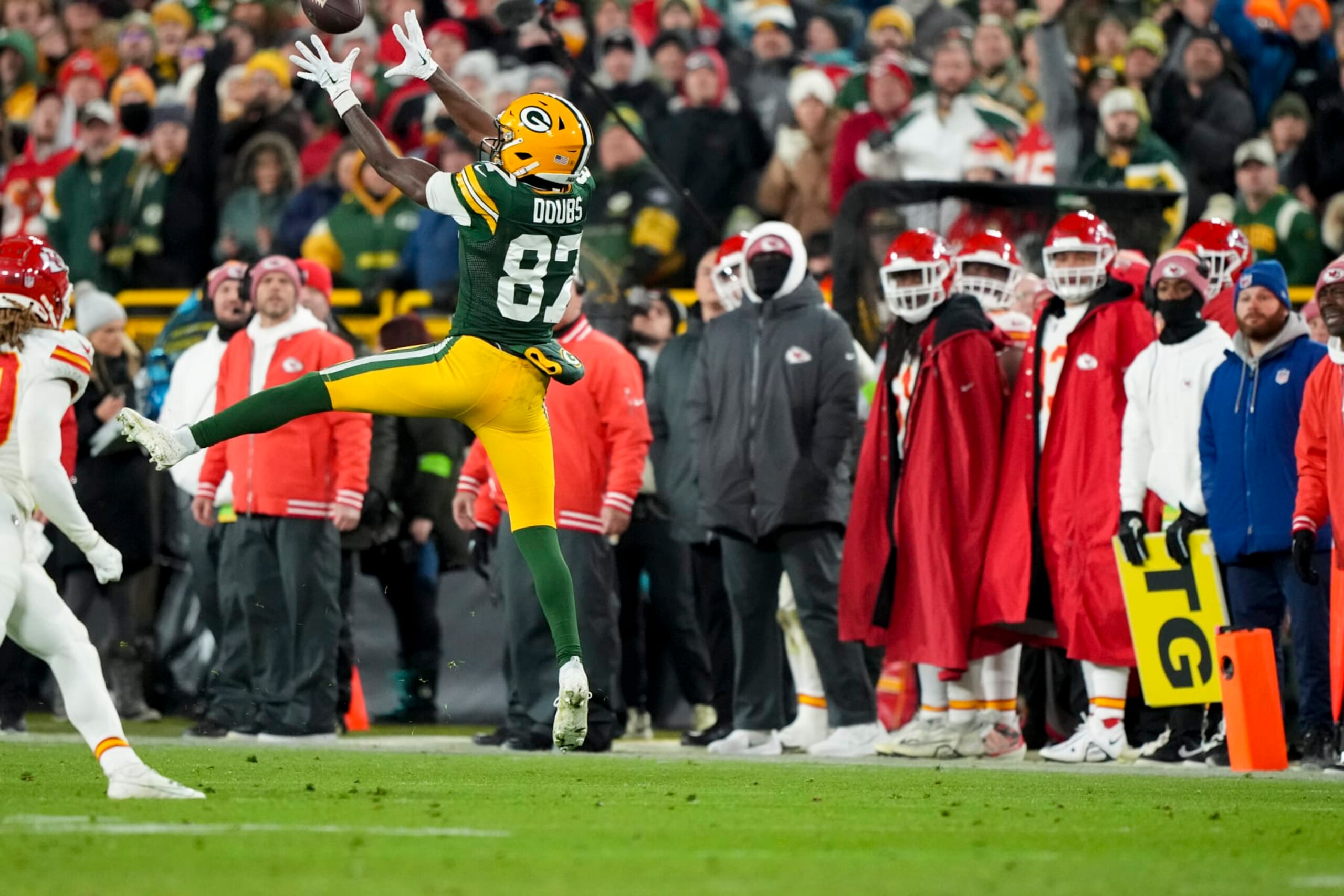 GREEN BAY, WI - DECEMBER 3: Wide receiver Romeo Doubs #87 of the Green Bay Packers jumps up for the ball during an NFL football game against the Kansas City Chiefs at Lambeau Field on December 3, 2023 in Green Bay, Wisconsin. (Photo by Todd Rosenberg/Getty Images)