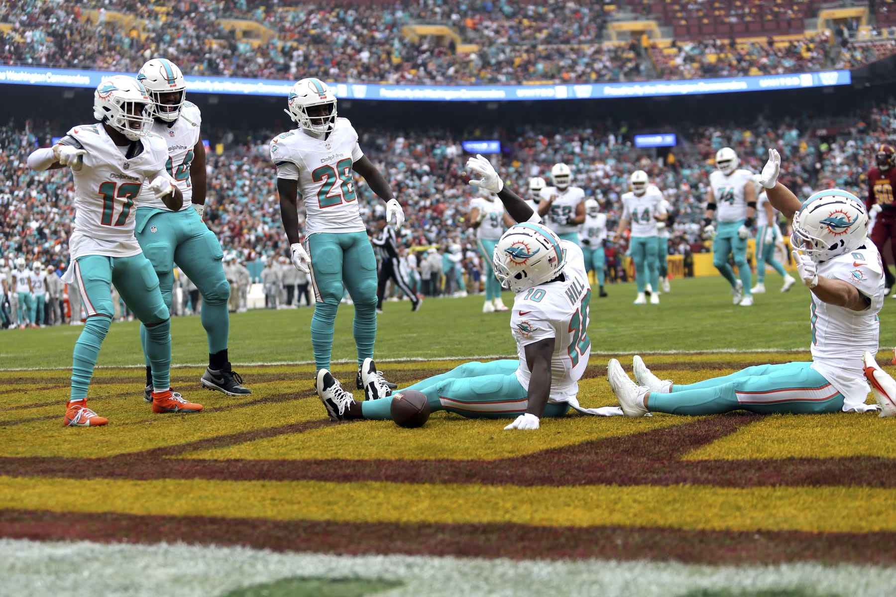 Miami Dolphins wide receiver Tyreek Hill (10) celebrates with his teammates after scoring a touchdown during an NFL football game against the Washington Commanders, Sunday, December 03, 2023 in Landover, Md. (AP Photo/Daniel Kucin Jr.)